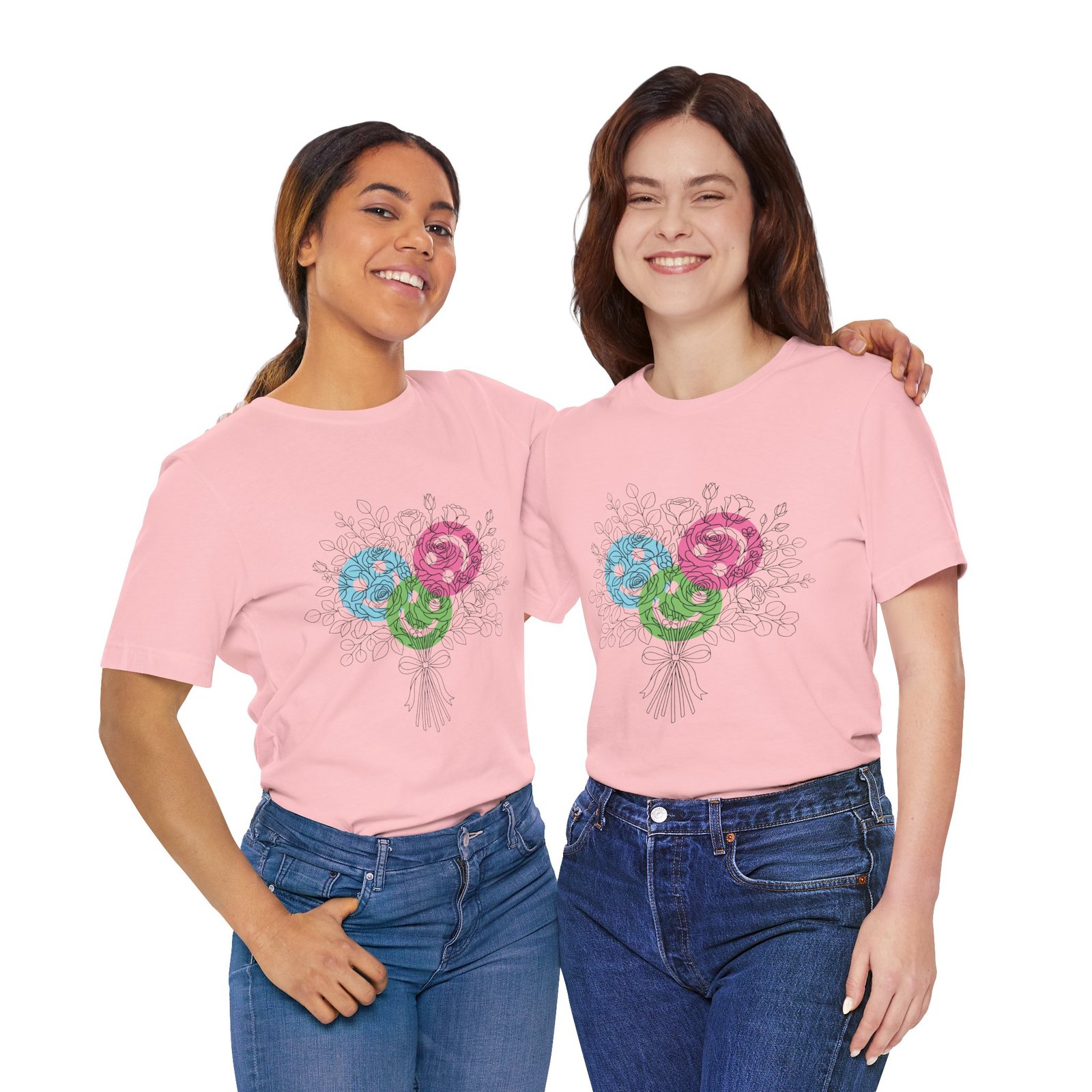 Two women wearing pink t-shirts featuring a colorful hand-drawn floral yarn bouquet design.