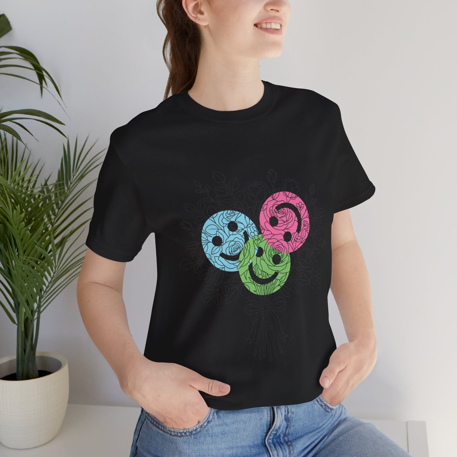 Black crew neck T-shirt featuring a hand-drawn bouquet of teal, magenta, and lime spiral flowers.