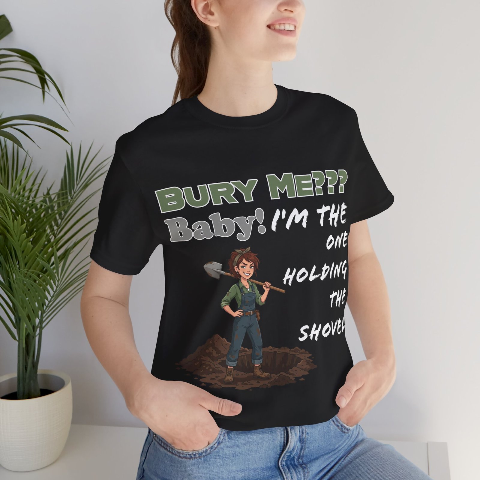 Black t-shirt featuring an illustrated character holding a shovel with dark humor text "Bury Me??? Baby! I'm the one holding the shovel"
