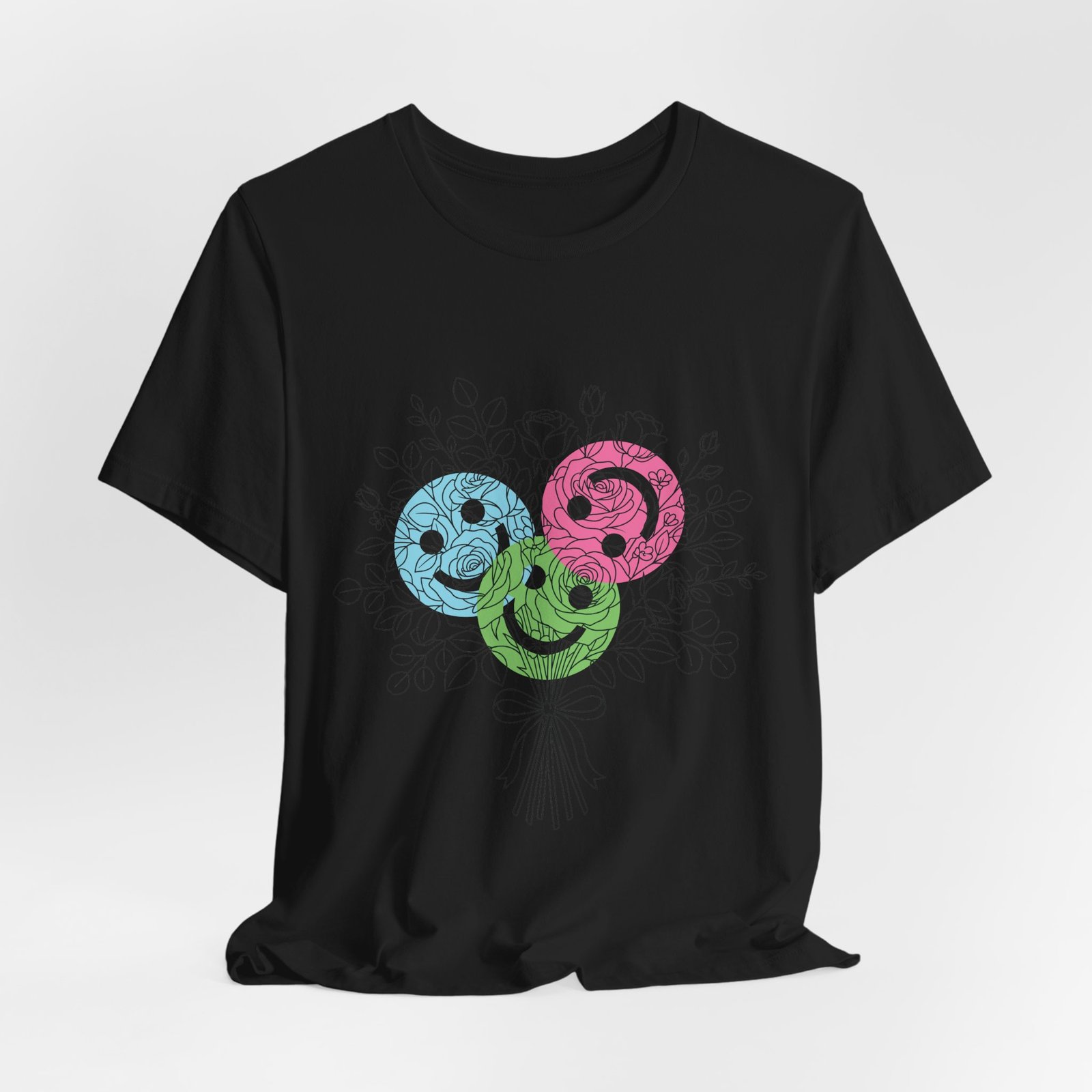 Black T-shirt featuring three colorful, spiral-shaped smiley face blooms in teal, magenta, and lime over a sketch bouquet.