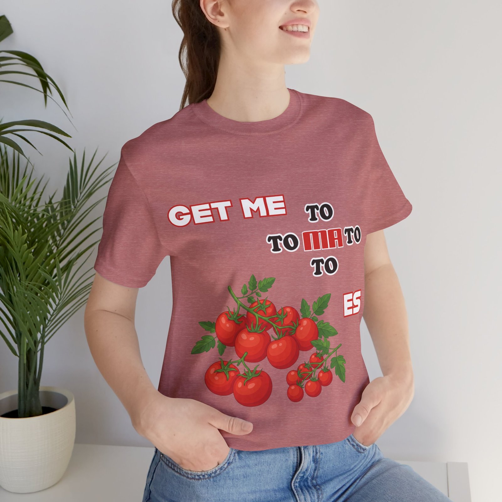 Dusty rose t-shirt featuring a playful 'Get Me To Ma To Toes' text and vibrant illustrations of red tomato clusters.