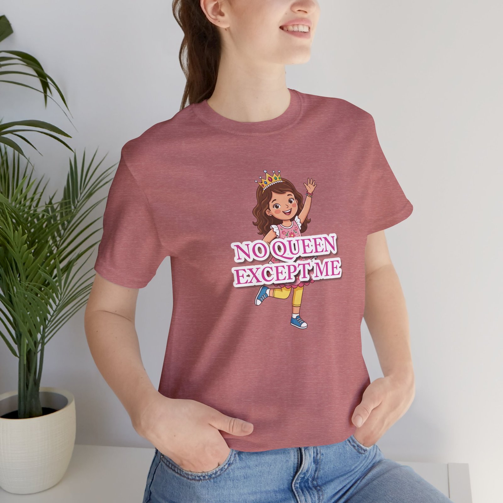 Girl wearing a pink "No Queen Except Me" t-shirt featuring a whimsical illustration of a little queen with a crown.
