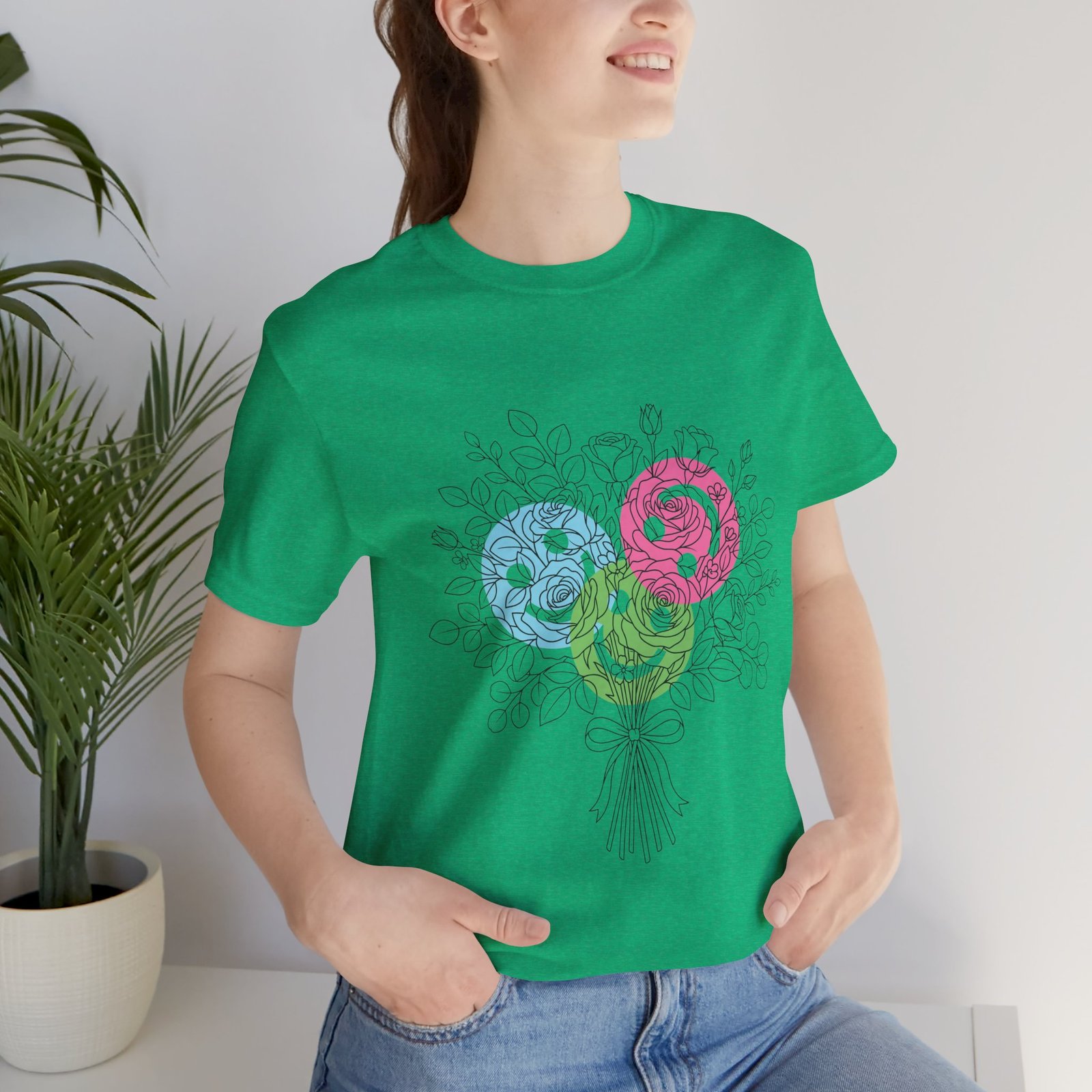 Green t-shirt featuring a hand-drawn floral bouquet with teal, magenta, and lime yarn-inspired spiral blooms.