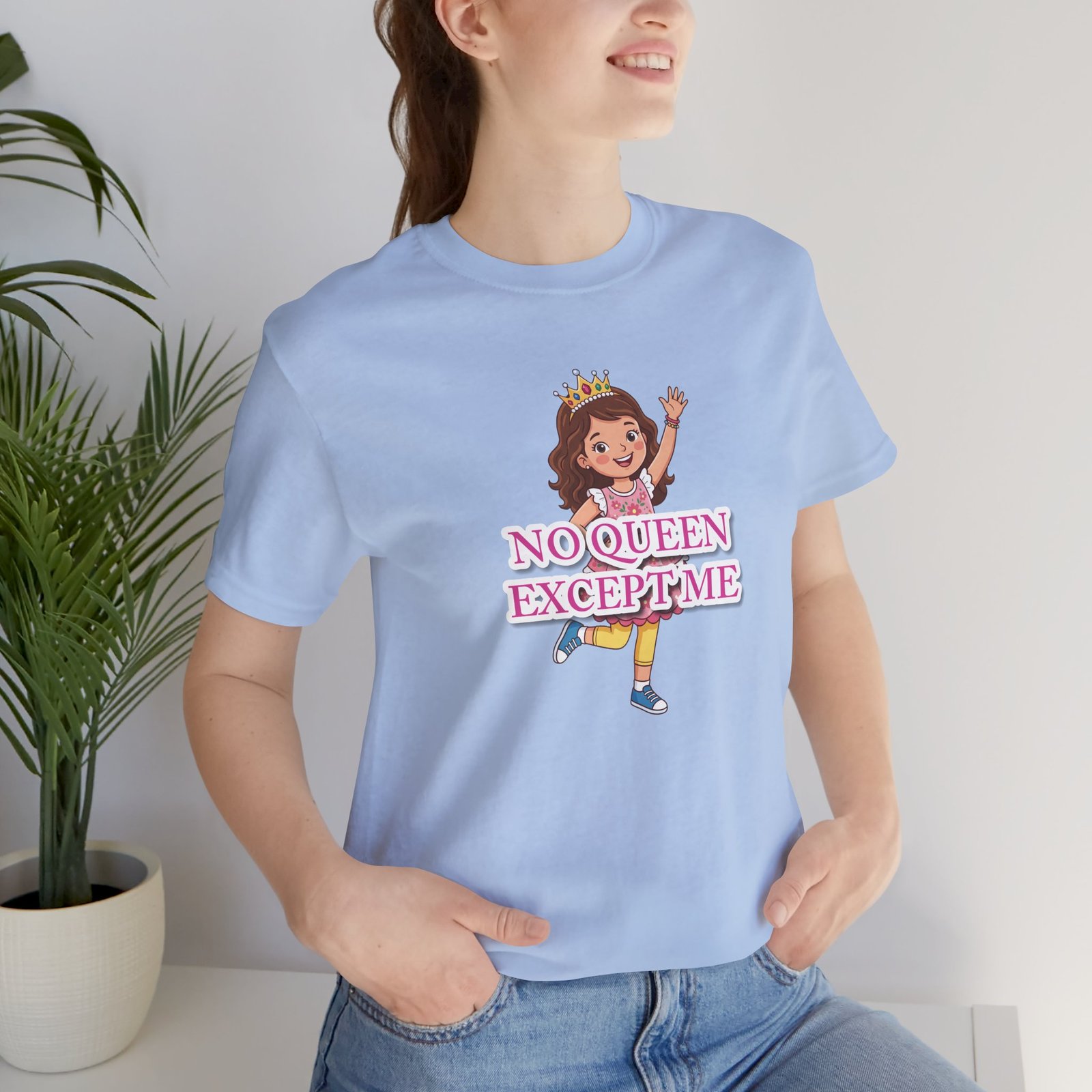 Light blue girls' t-shirt featuring a whimsical illustration of a girl with a crown and pink text "NO QUEEN EXCEPT ME".