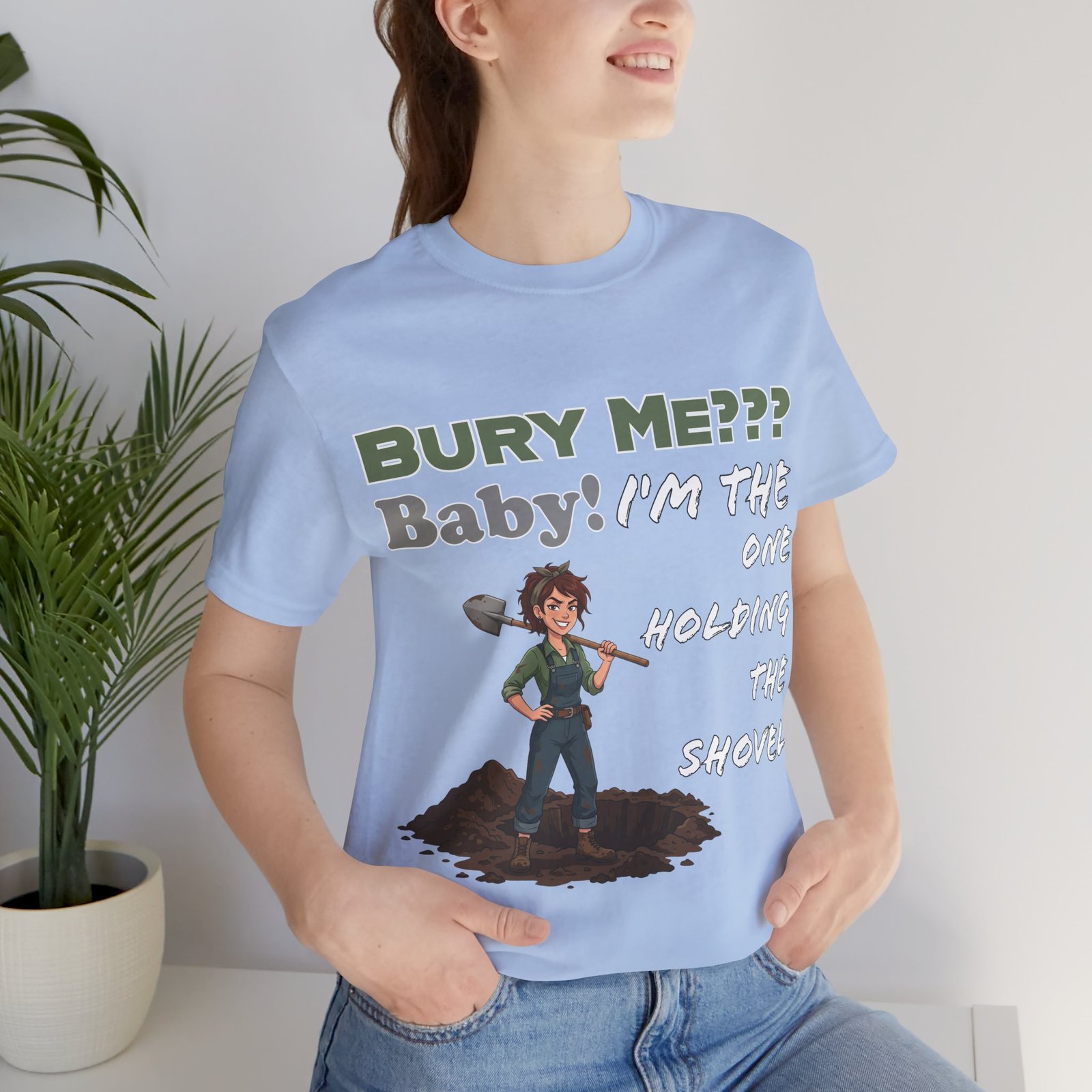 Light blue t-shirt featuring a dark humor graphic of a character with a shovel and the text 'Bury Me??? Baby! I'm the One Holding the Shovel'