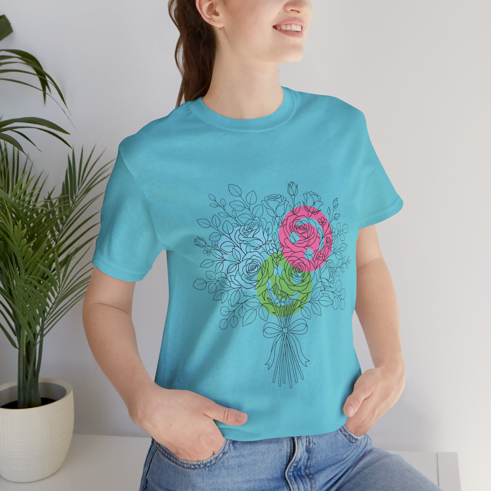 Light blue t-shirt featuring a hand-drawn bouquet of teal, magenta, and lime yarn-style floral blooms.