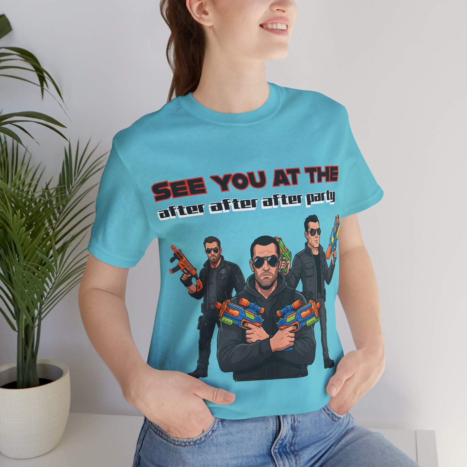 Light blue T-shirt featuring three cartoon characters in sunglasses wielding colorful toy water guns and cheeky text.