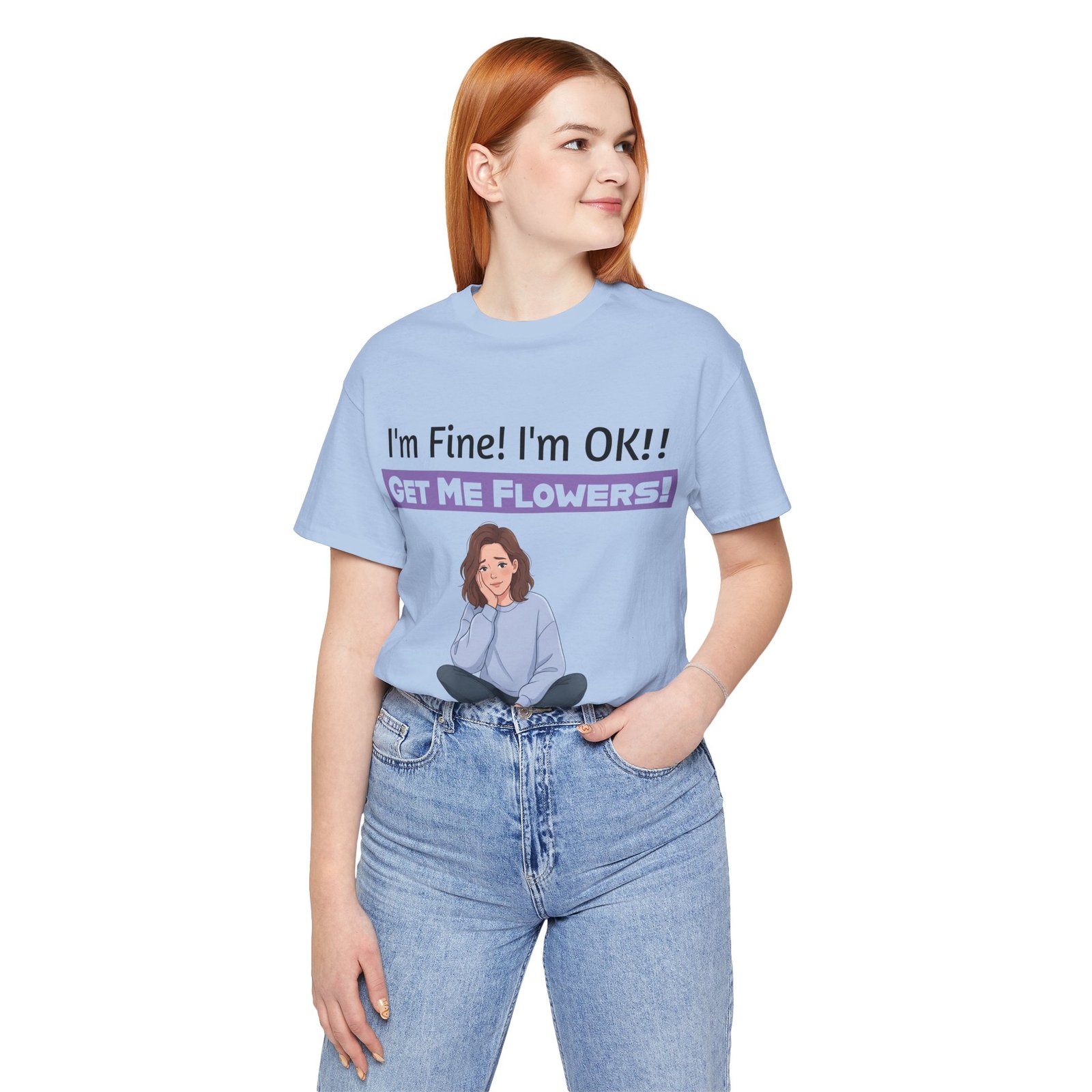Light blue t-shirt with an illustration of a girl and text saying I'm Fine! I'm OK!! GET ME FLOWERS!