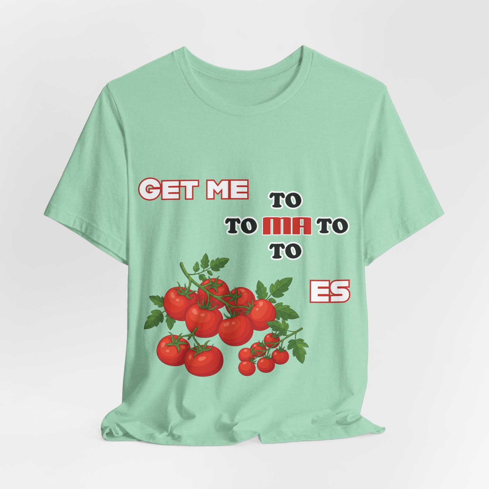 Light green t-shirt featuring a bold retro 'Get Me To Ma To Toes' phrase and vibrant illustrated tomato clusters.
