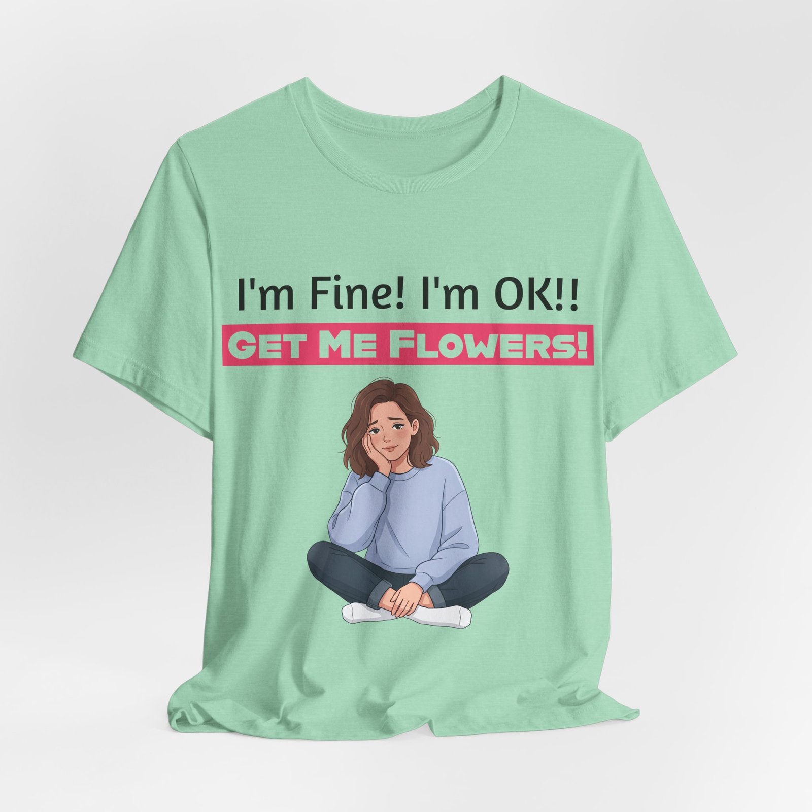 Mint green t-shirt featuring a funny illustration of a seated person and the text "I'm Fine! I'm OK!! GET ME FLOWERS!"