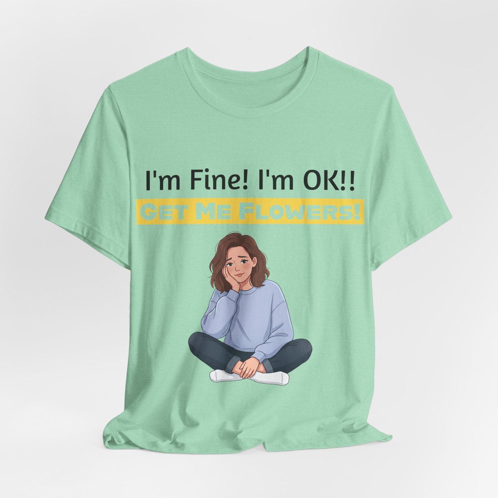 Mint green t-shirt with a funny illustration of a woman and text that reads 'I'm Fine! I'm OK!! GET ME FLOWERS!'