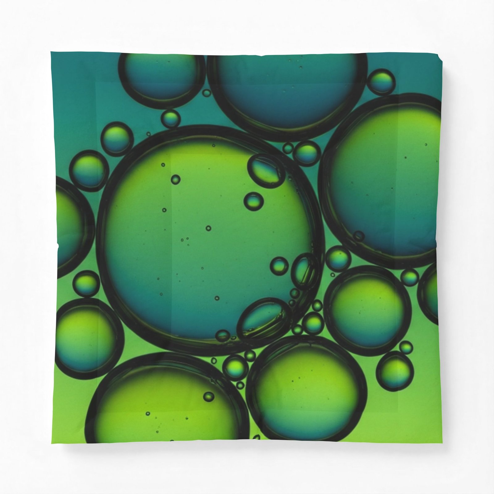 Modern geometric cotton comforter featuring an abstract print of overlapping teal and green bubbles.