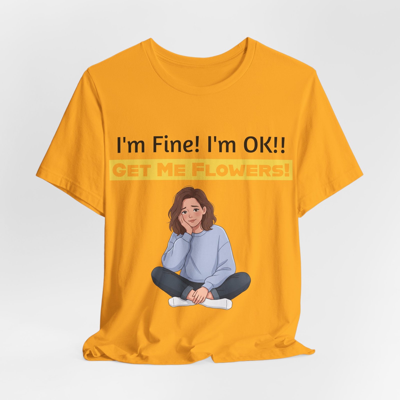 Mustard yellow T-shirt featuring an illustration of a person and the text "I'm Fine! I'm OK!! GET ME FLOWERS!"