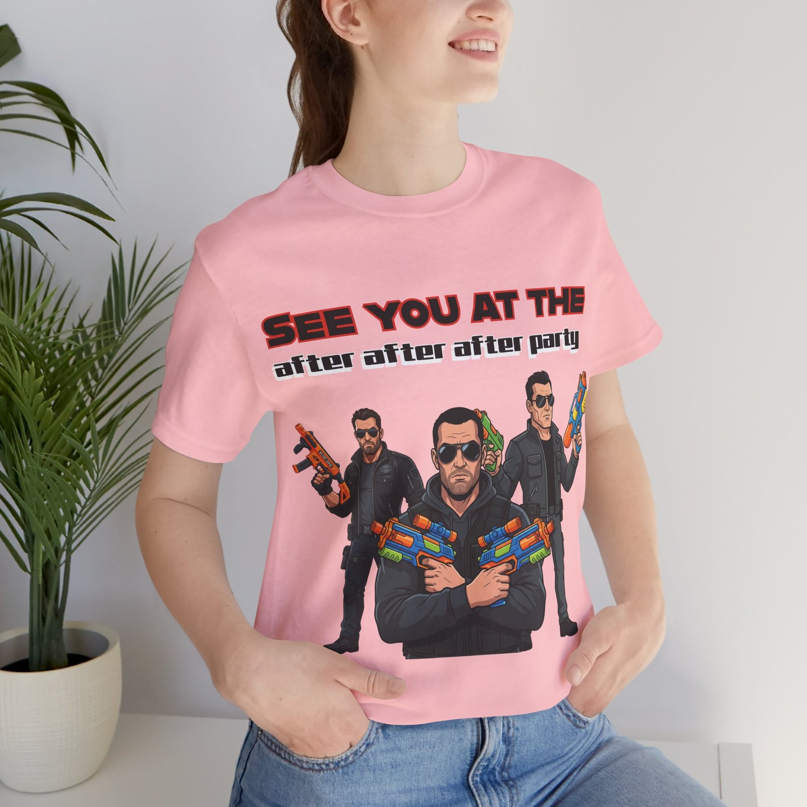 Person wearing a pink "See You At The After After After Party" T-shirt featuring three characters with toy water guns.