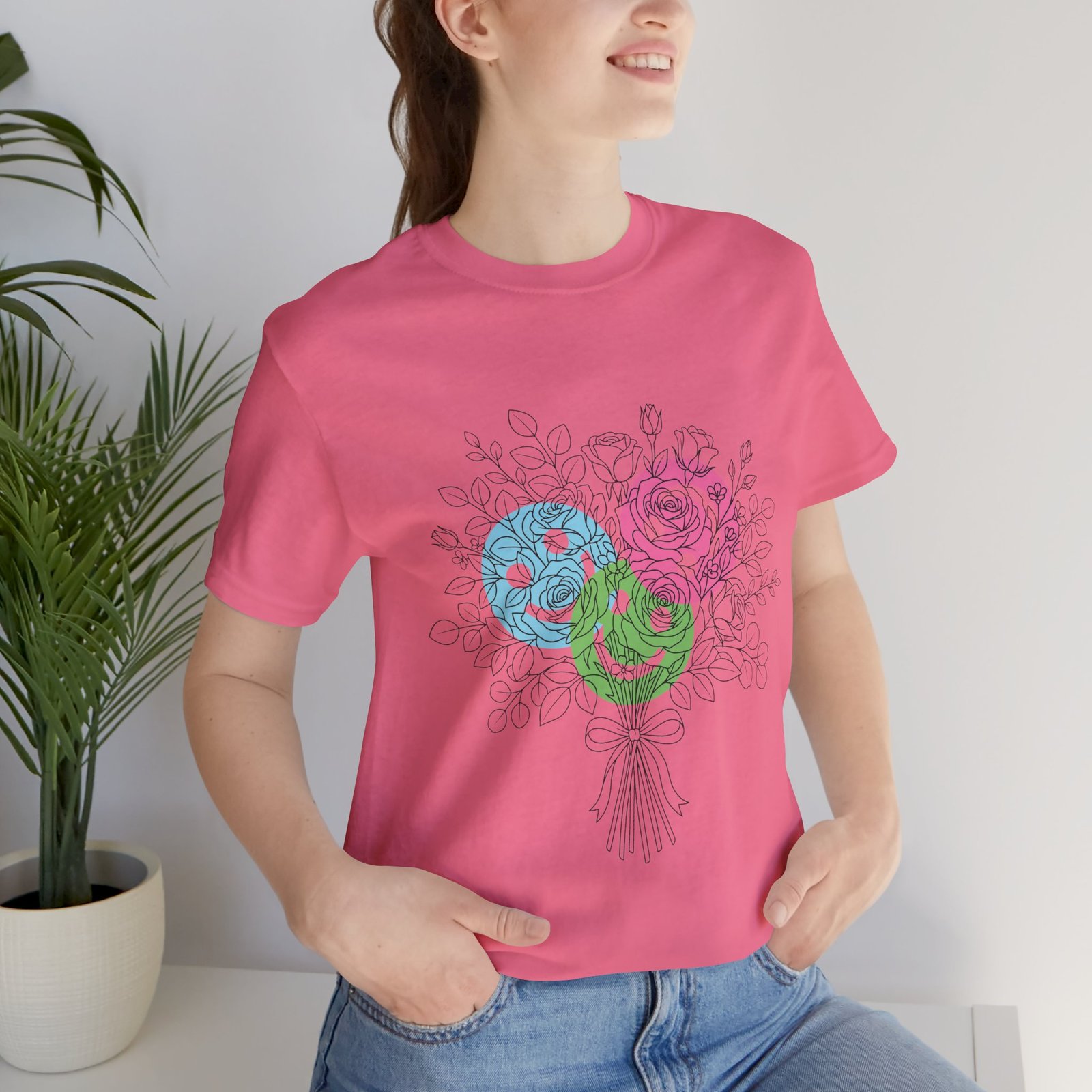Pink t-shirt featuring a hand-drawn bouquet of colorful teal, magenta, and lime spiral flowers.