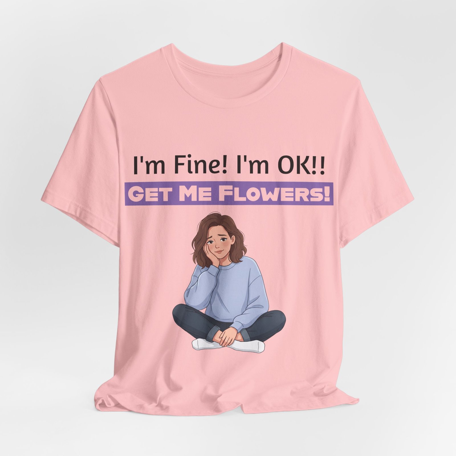 Pink T-shirt featuring an illustration of a girl and the text I'm Fine! I'm OK!! GET ME FLOWERS!