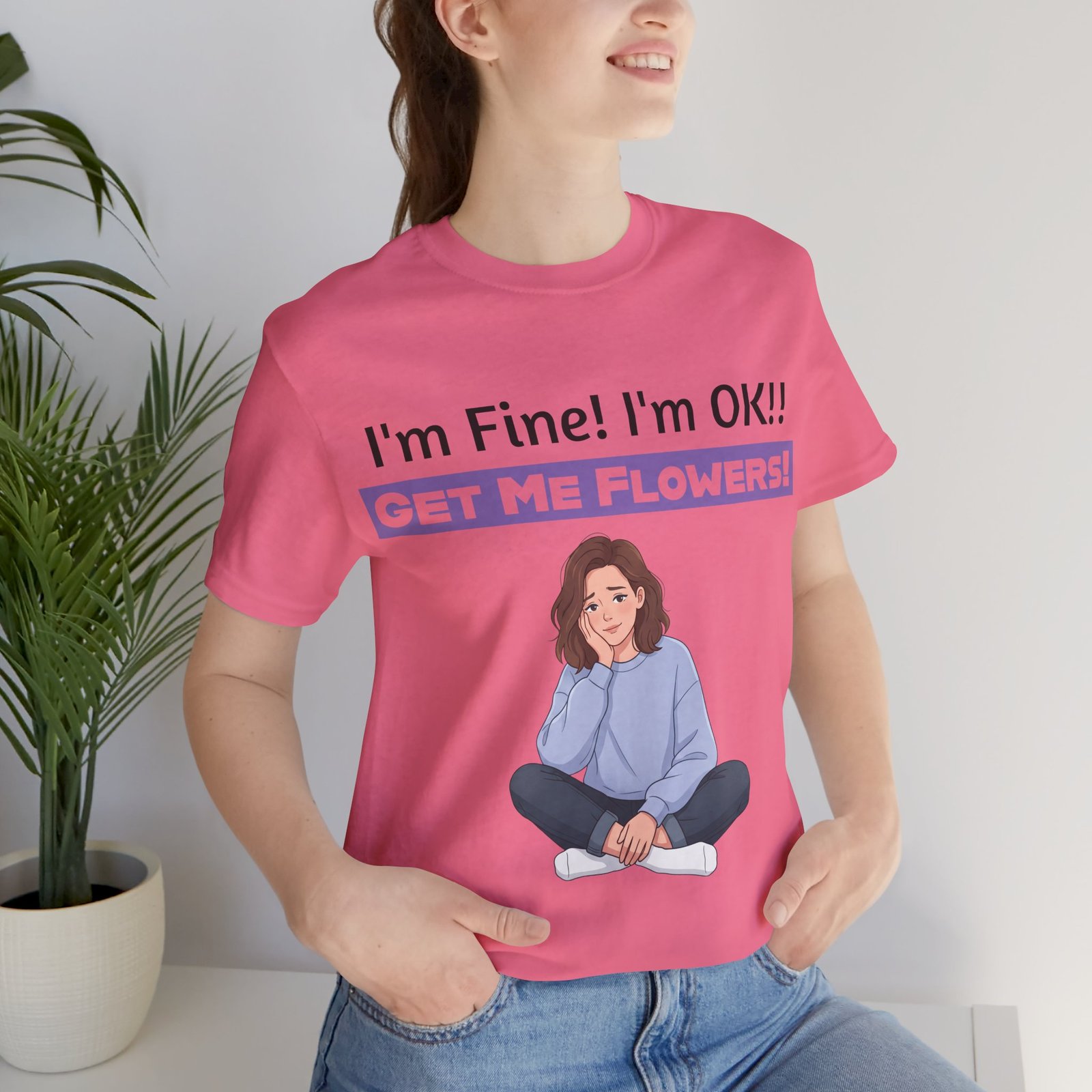 Pink t-shirt with an illustration of a girl and the funny text I'm Fine! I'm OK!! GET ME FLOWERS!