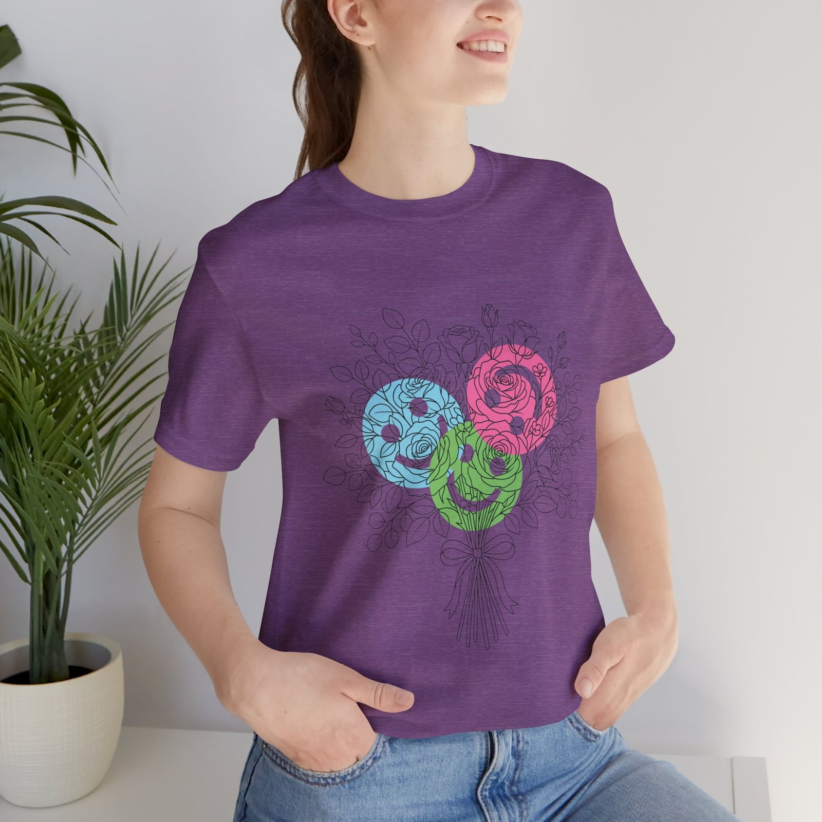 Purple crew neck t-shirt featuring a hand-drawn bouquet of teal, magenta, and lime spiral yarn-style flowers.