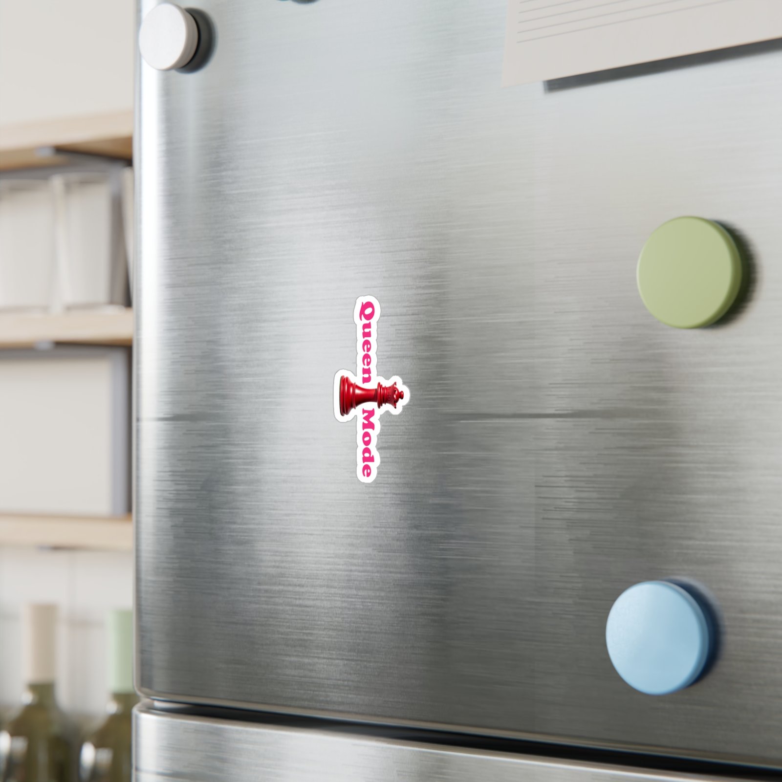 Queen Mode Red Chess Queen sticker with pink vertical text applied to a stainless steel surface.