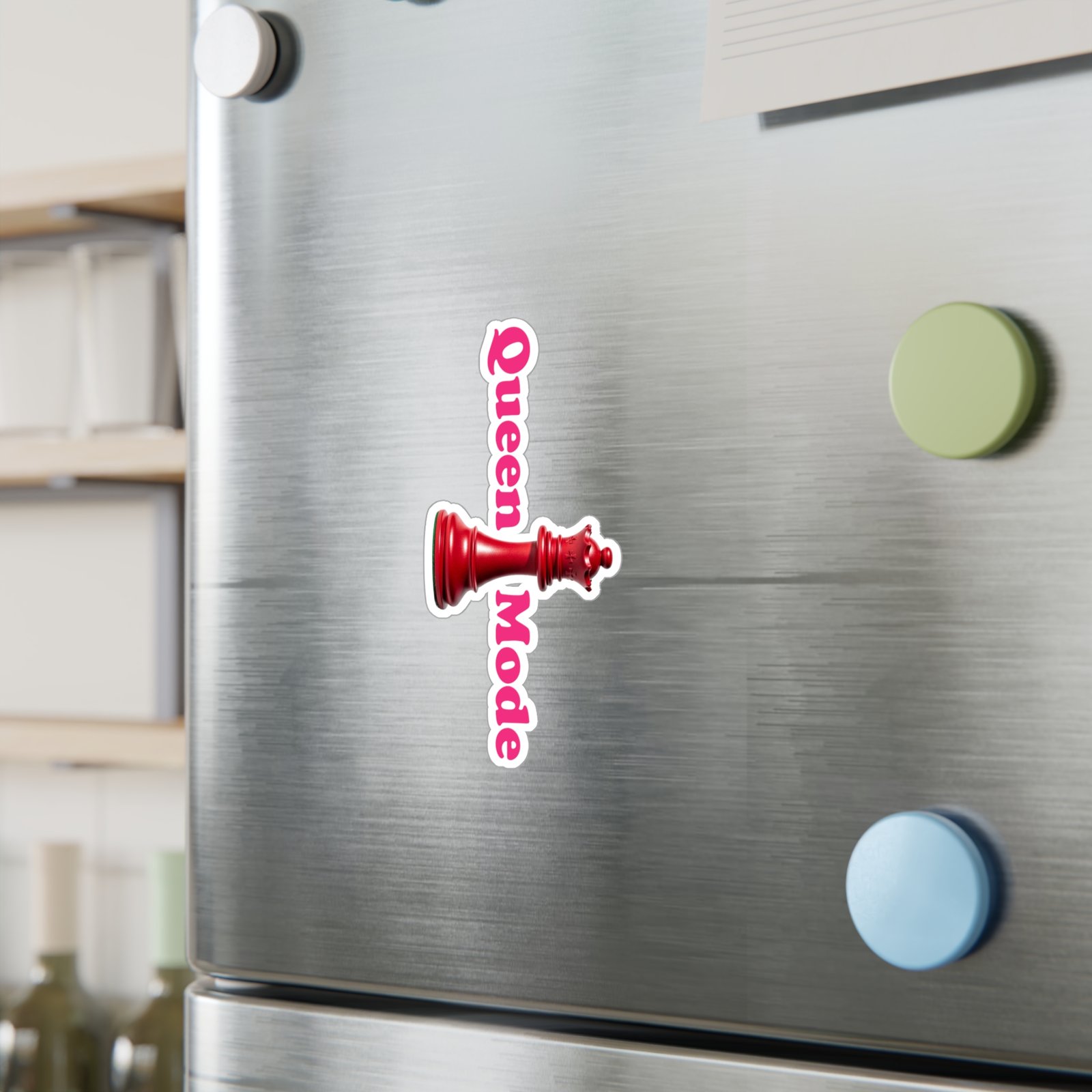 Queen Mode red chess queen sticker with pink vertical text on a stainless steel refrigerator surface.
