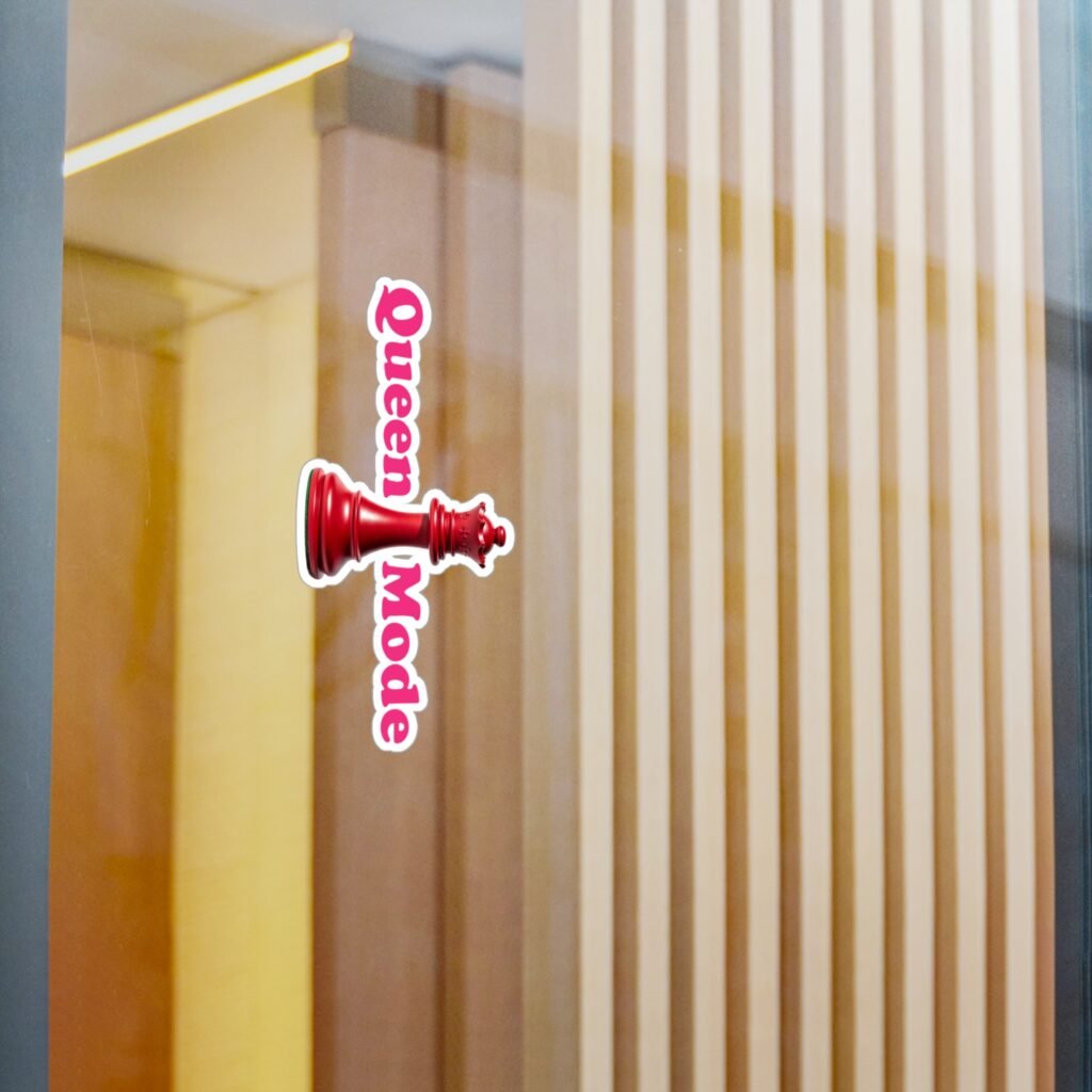 Queen Mode red chess queen sticker with vertical pink text on a glass surface