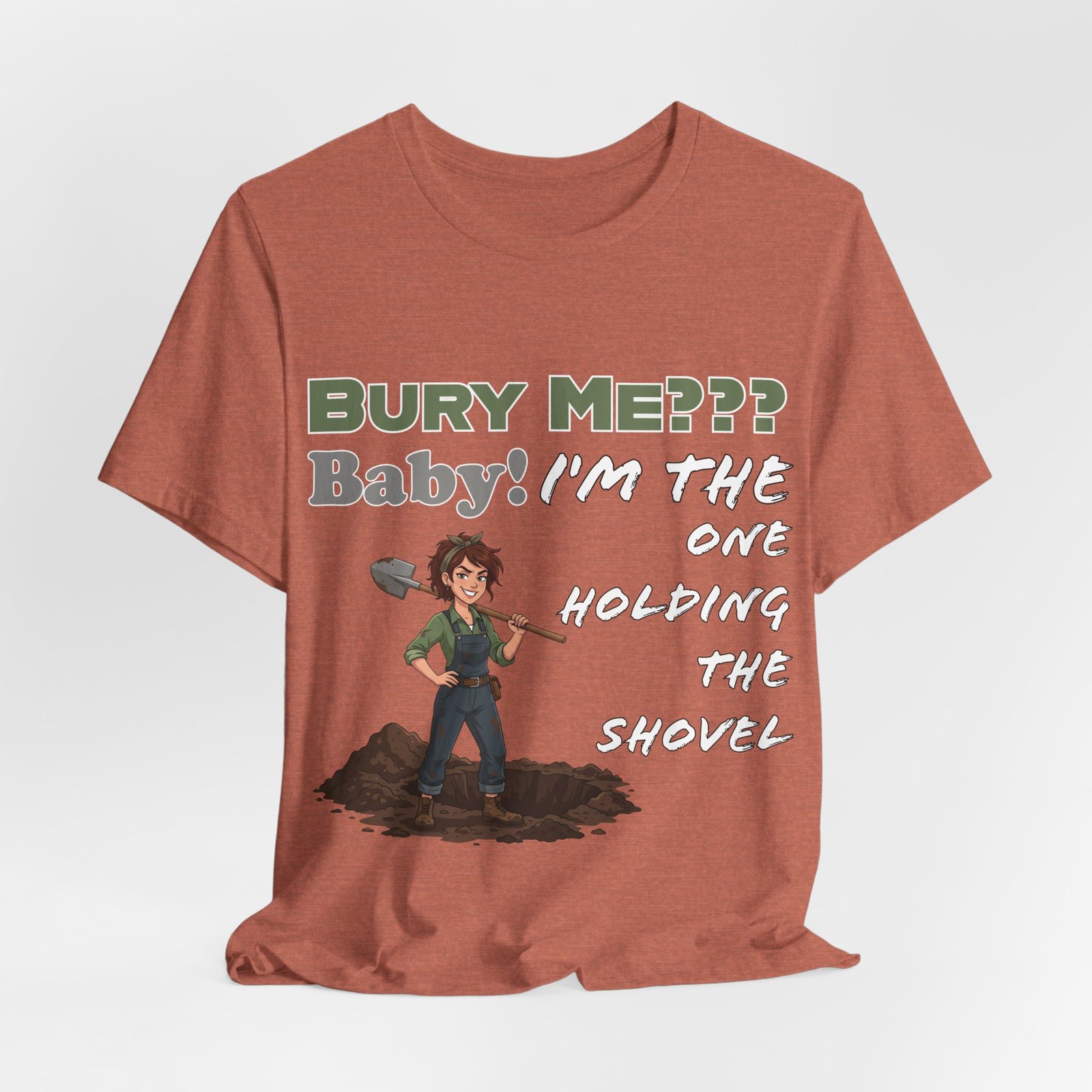 Rust-colored t-shirt featuring an illustrated character with a shovel and text "Bury Me??? Baby! I'm the One Holding the Shovel"