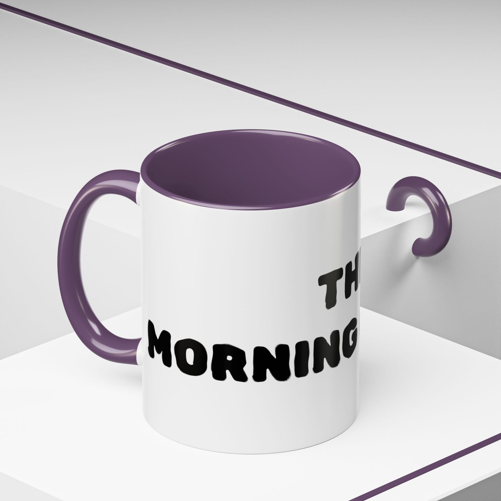 The Morning Coffee ceramic mug with white exterior, purple interior, and chunky black lettering.