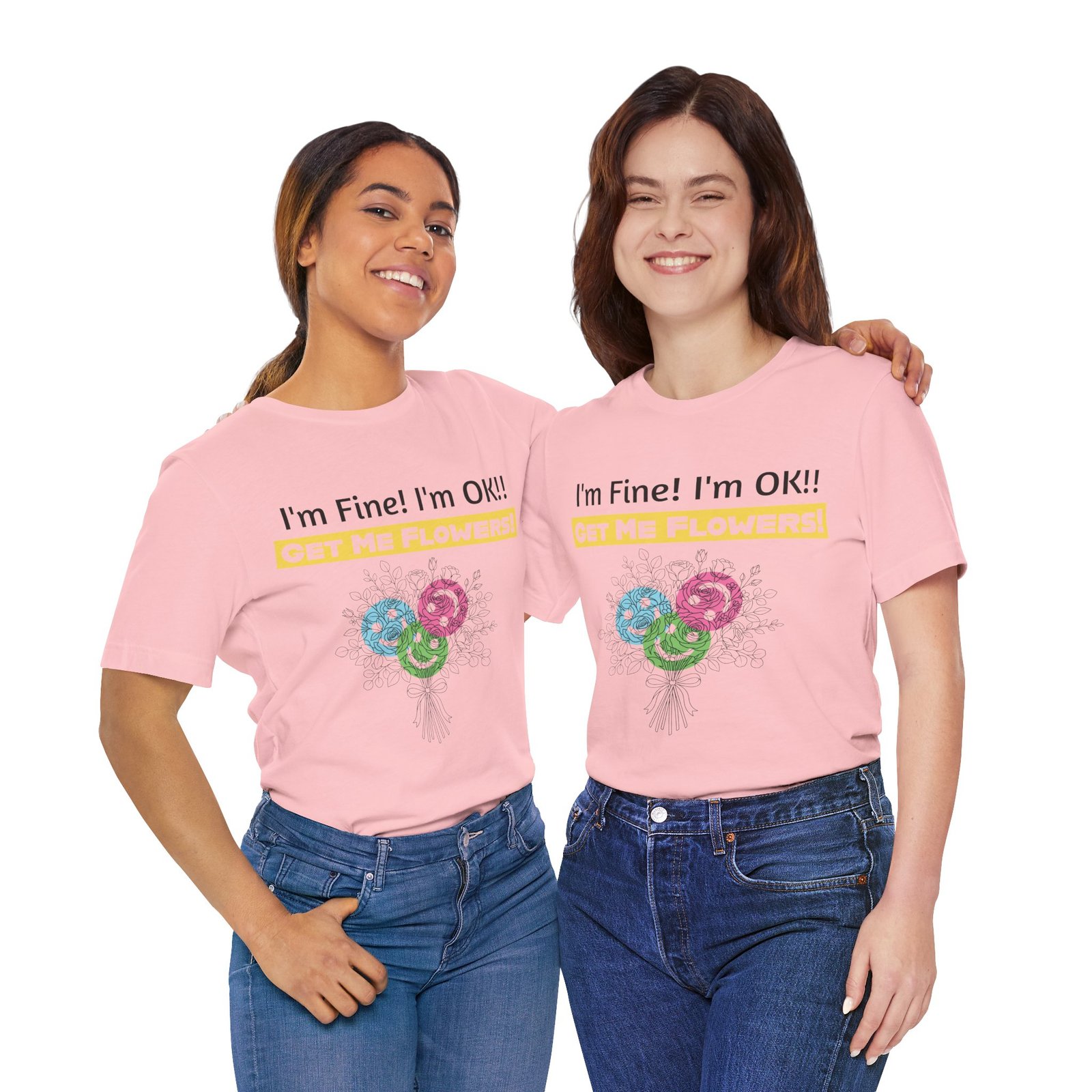 Two smiling women wearing pink t-shirts featuring the graphic 'I'm Fine! I'm OK!! GET ME FLOWERS!' and colorful blooms.