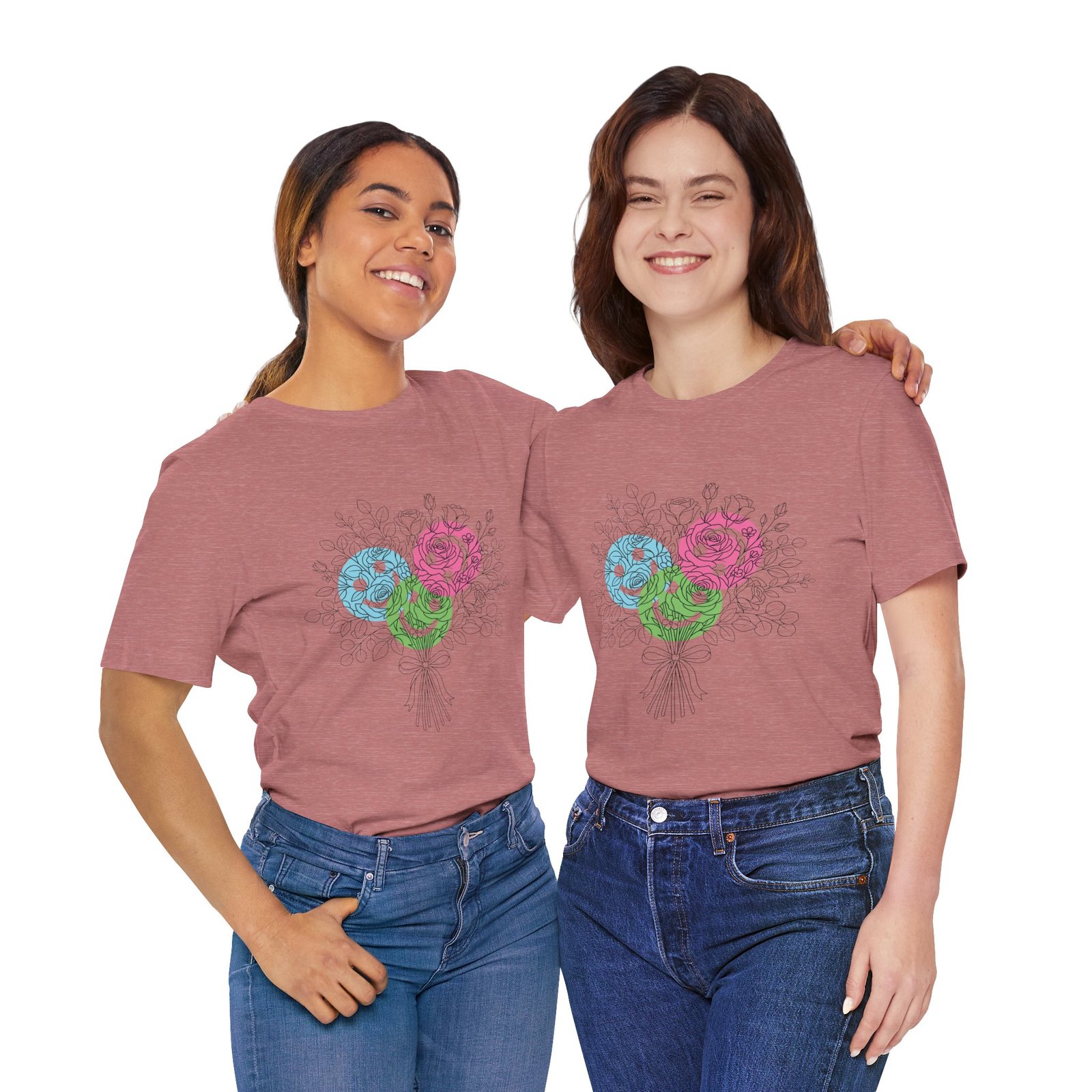 Two women smiling while wearing a dusty rose T-shirt featuring a colorful hand-drawn floral yarn bouquet graphic.