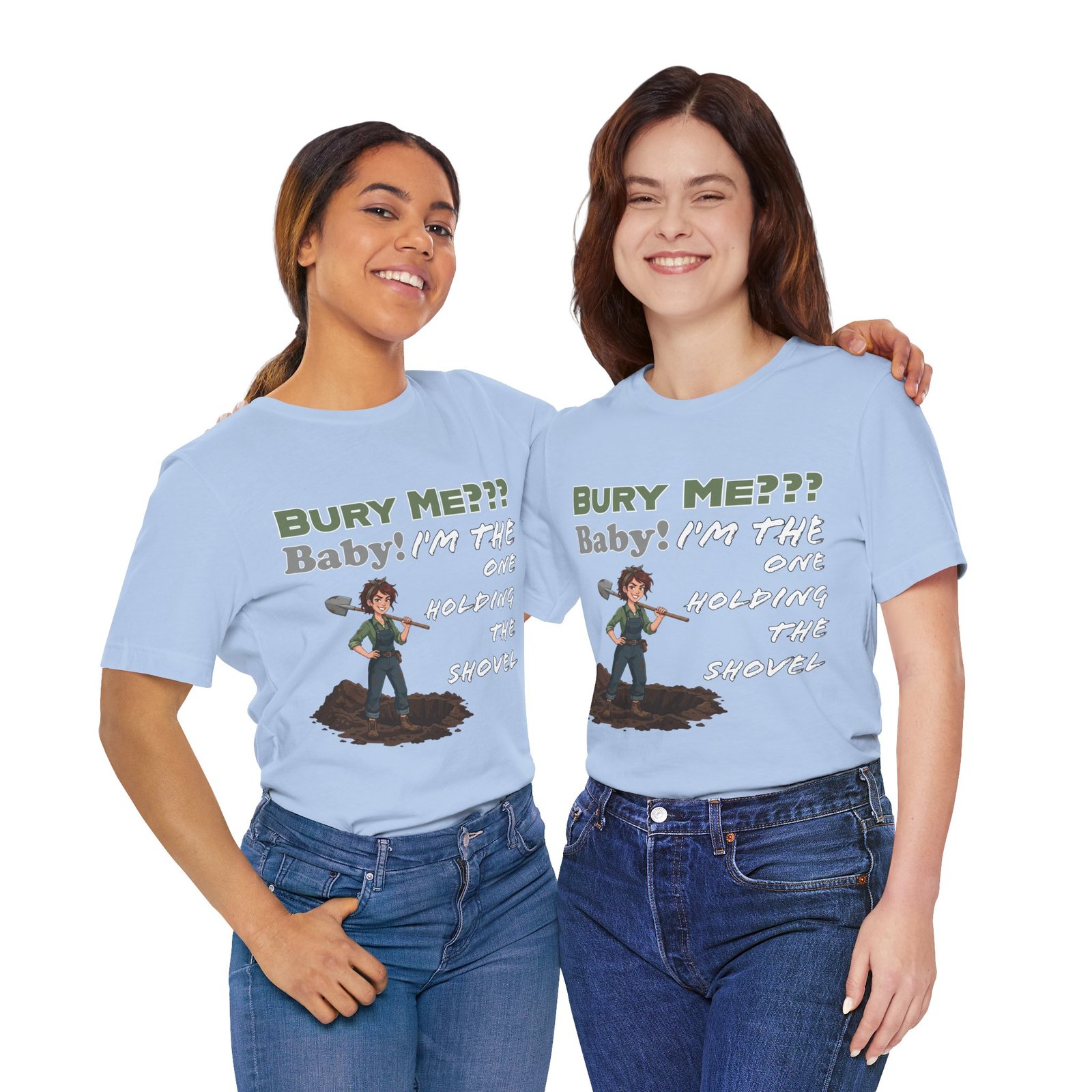 Two women smiling while wearing light blue T-shirts featuring dark humor text and an illustrated character with a shovel.