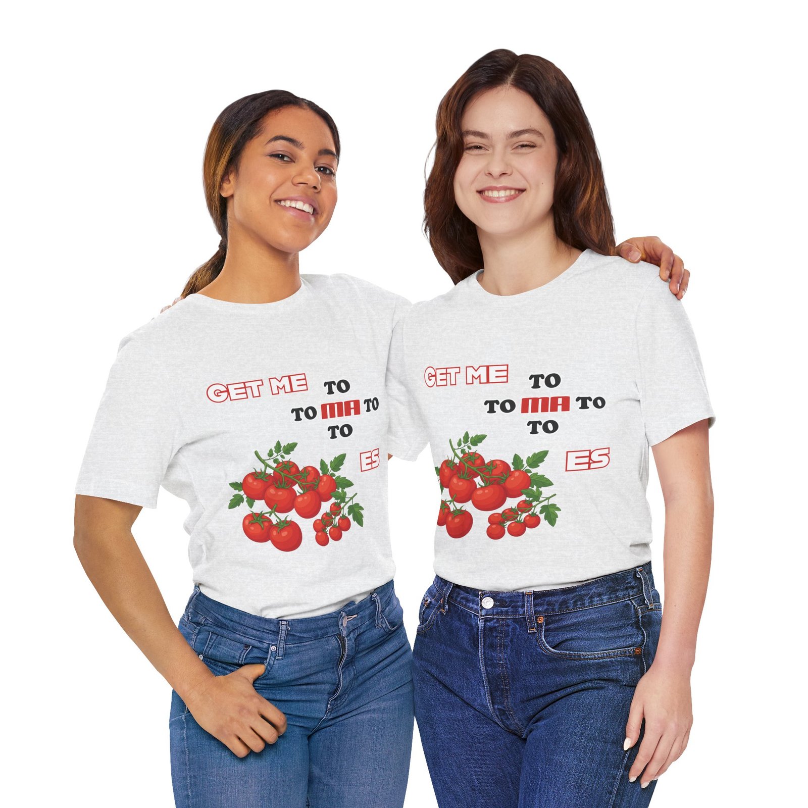 Two women smiling while wearing matching white Get Me To Ma To Toes t-shirts featuring red tomato illustrations.