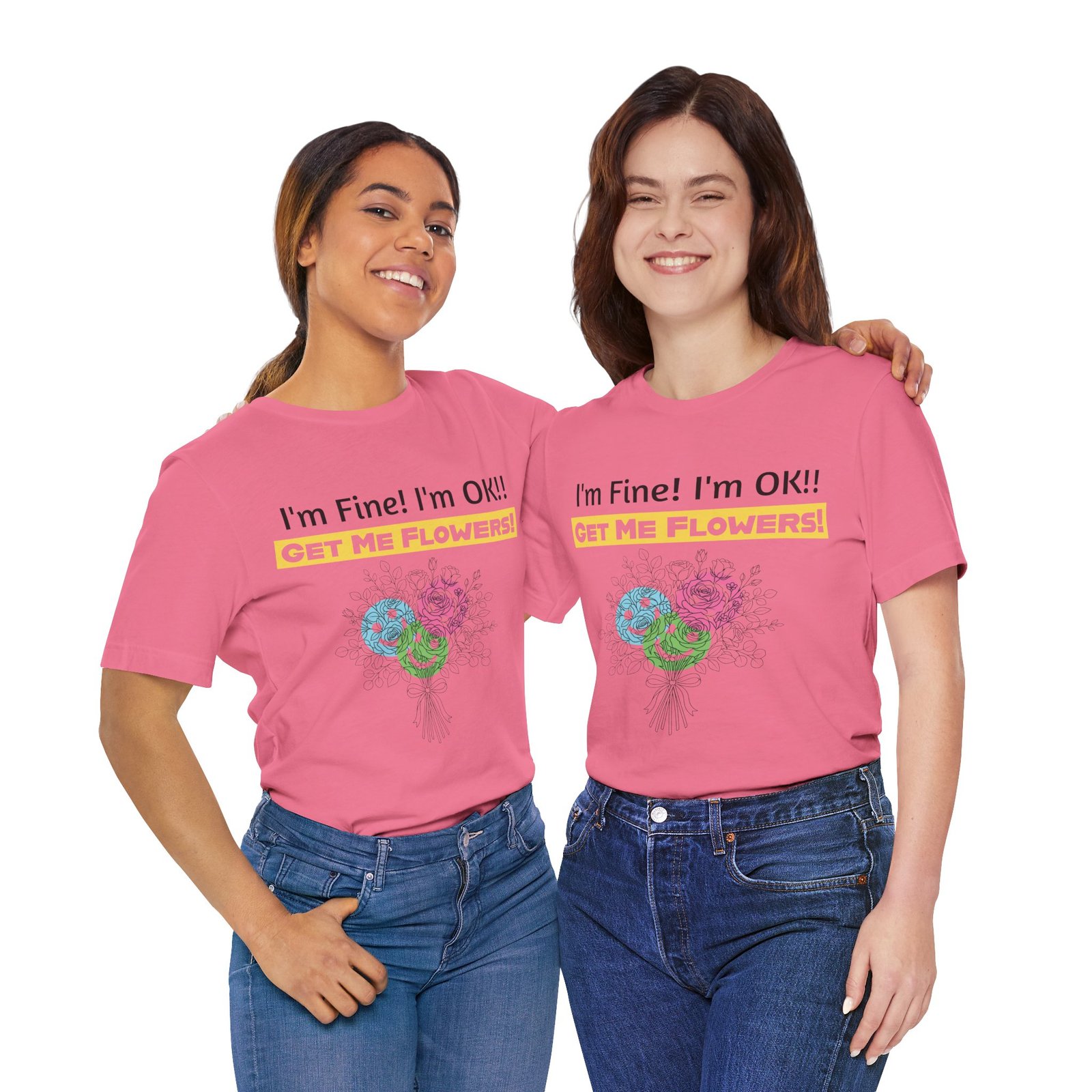 Two women smiling while wearing pink crew-neck t-shirts featuring a floral bouquet and text "I'm Fine! I'm OK!! Get Me Flowers!"