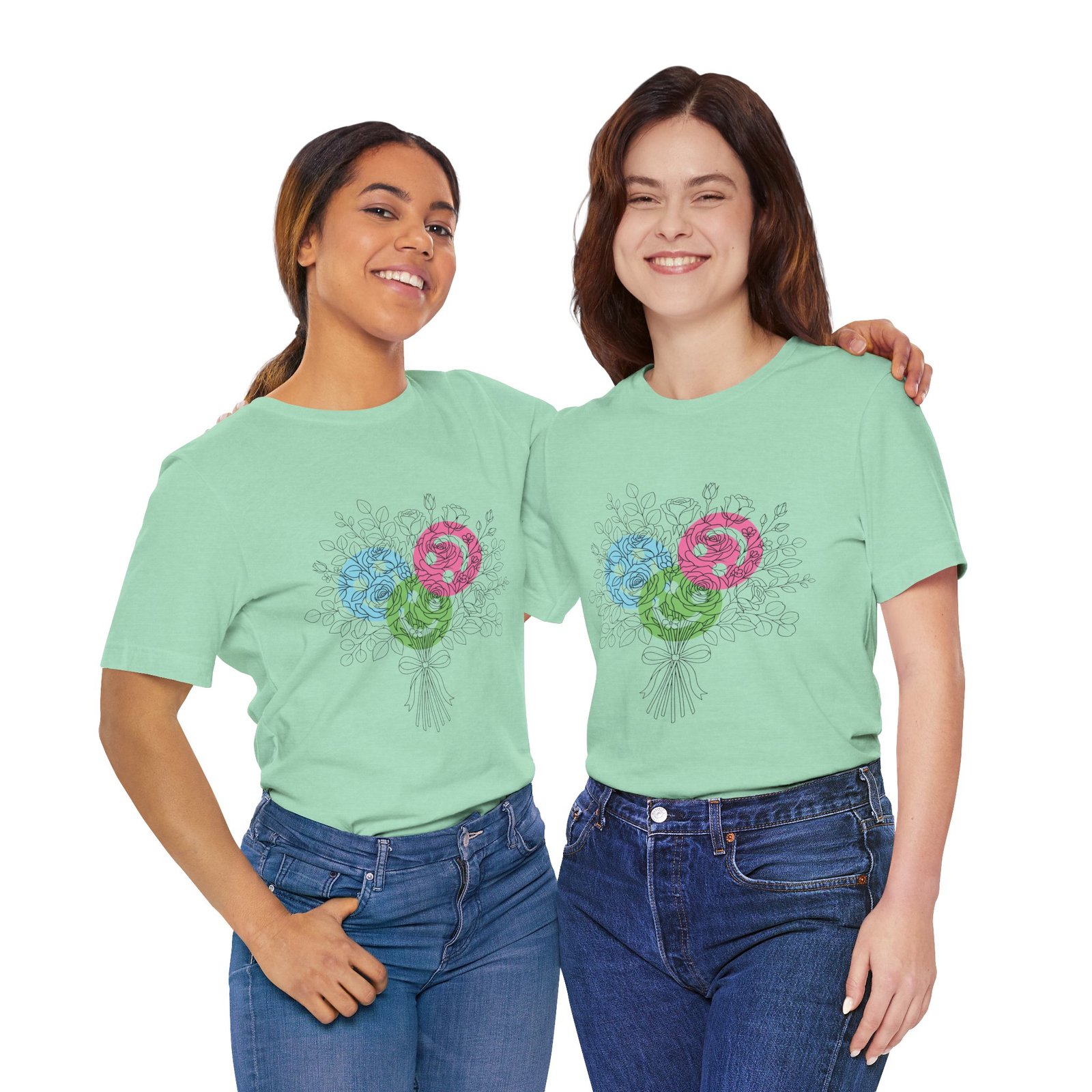 Two women wearing mint green t-shirts featuring a colorful hand-drawn floral yarn bouquet design.