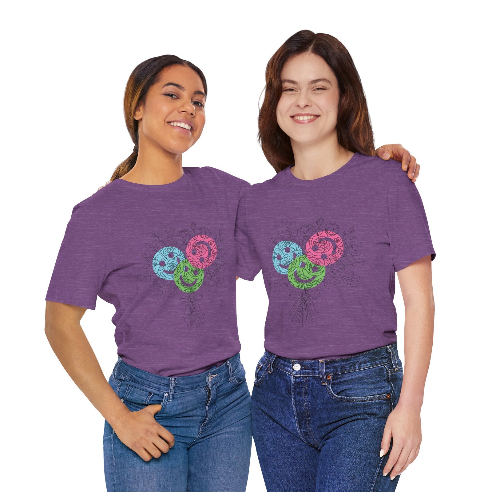 Two women wearing purple crew neck T-shirts featuring a colorful floral yarn bouquet graphic in teal, magenta, and lime.
