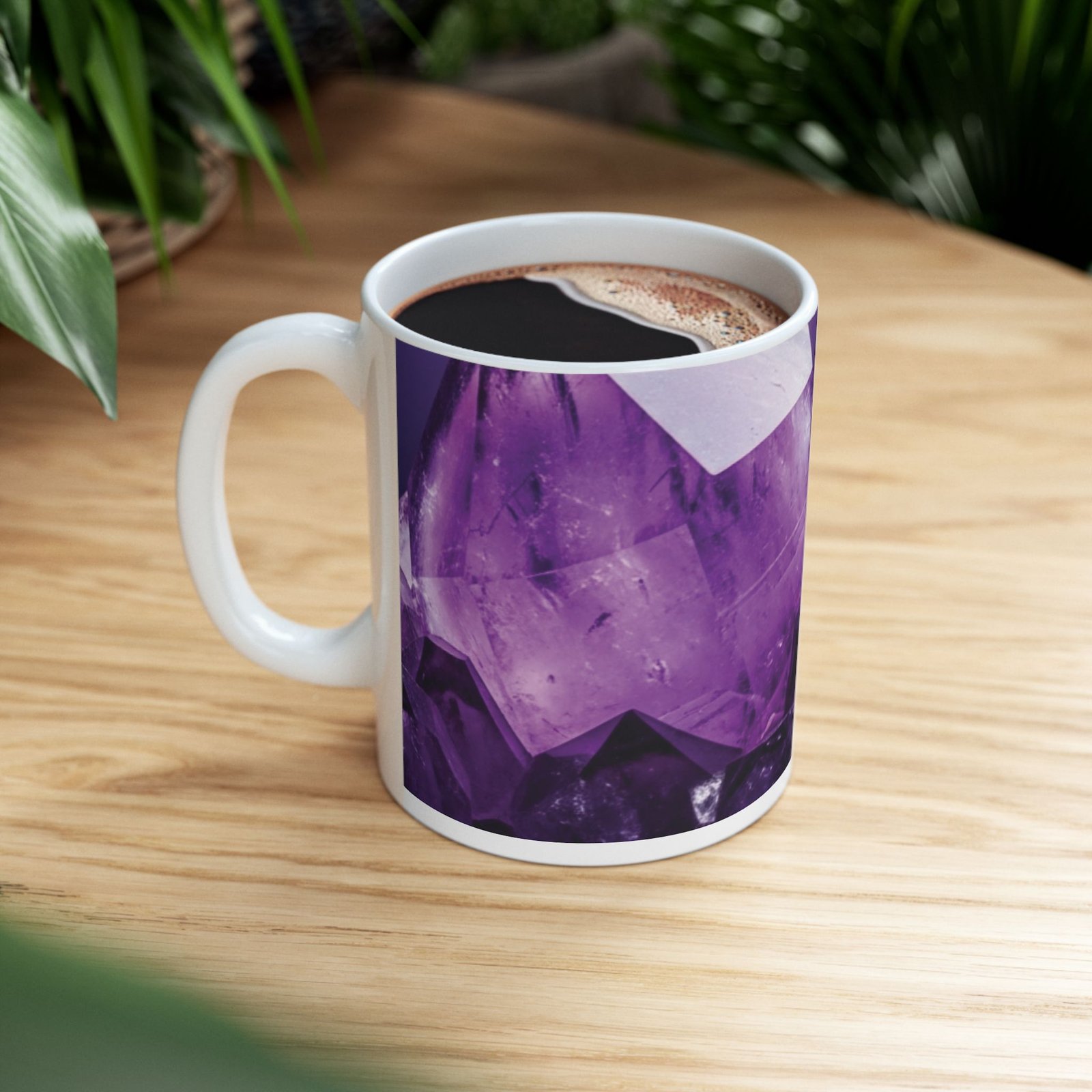 White ceramic mug with a vibrant purple amethyst crystal pattern, filled with coffee and resting on a wooden surface.
