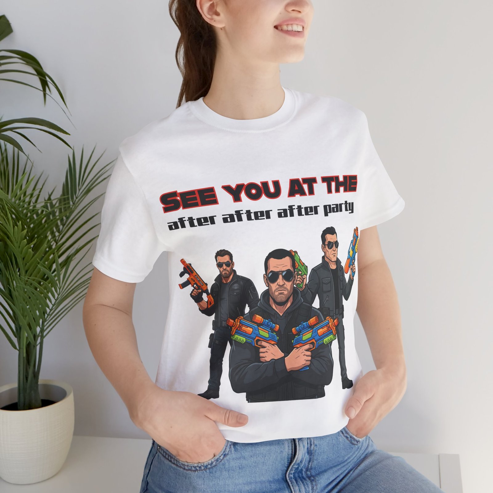 White t-shirt featuring a graphic of three characters in sunglasses holding colorful toy blasters and party text.