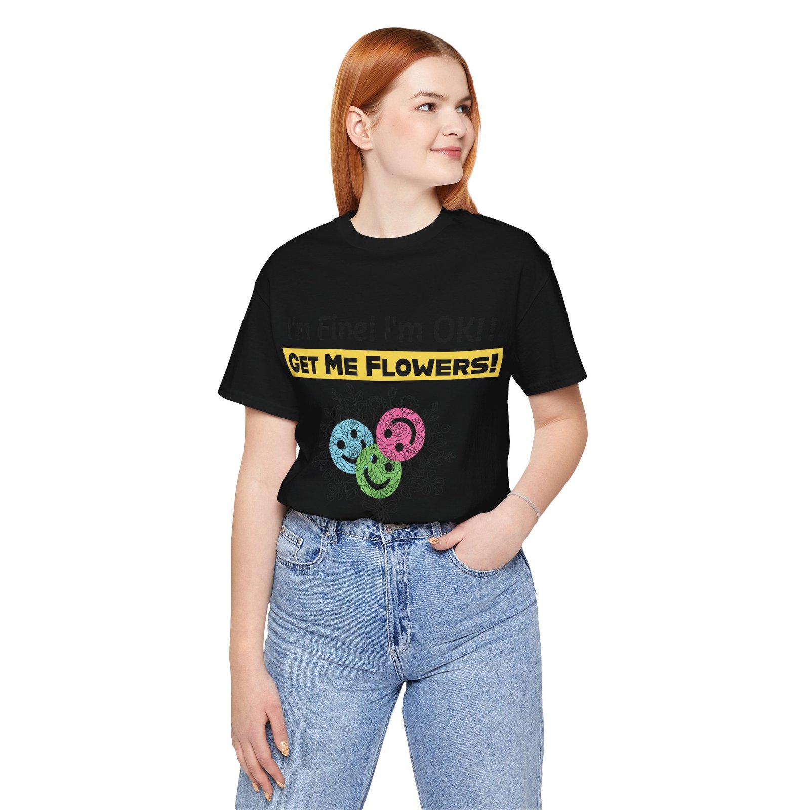 Woman wearing a black crew-neck T-shirt with colorful smiley flower graphics and the text "I'm Fine! I'm OK!! GET ME FLOWERS!"