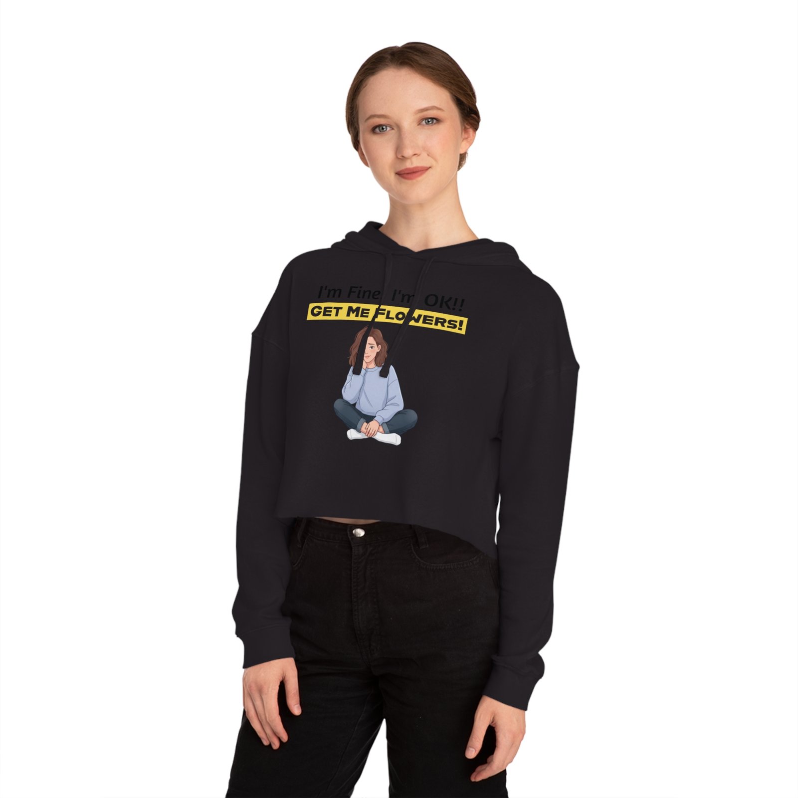 Woman wearing a black cropped hoodie with a graphic of a girl sitting and the text I'm Fine! I'm OK!! GET ME FLOWERS!