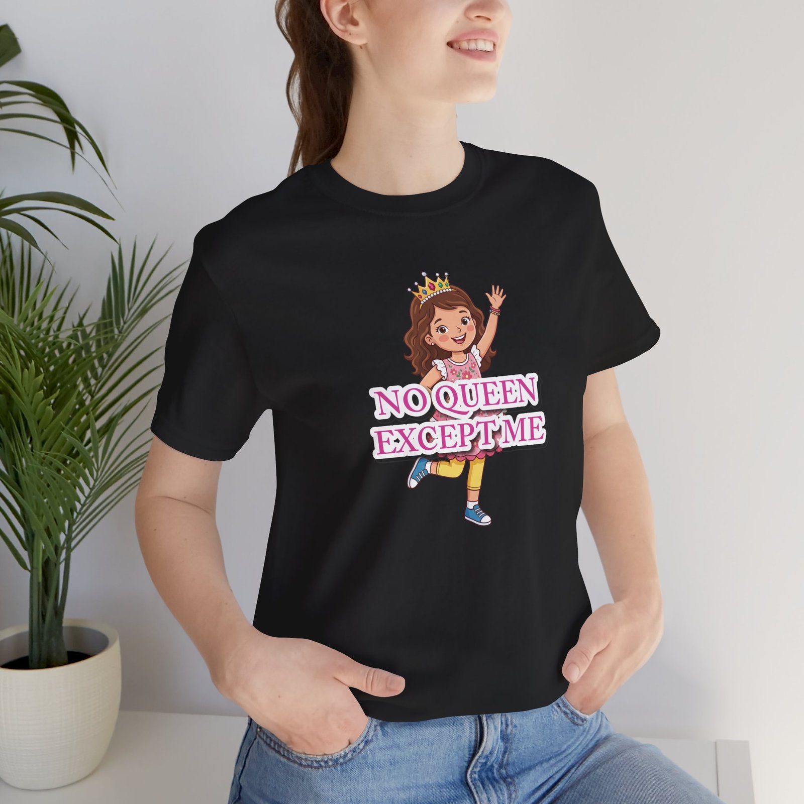Woman wearing a black No Queen Except Me Girls' T-Shirt featuring a cartoon girl with a crown and pink lettering.