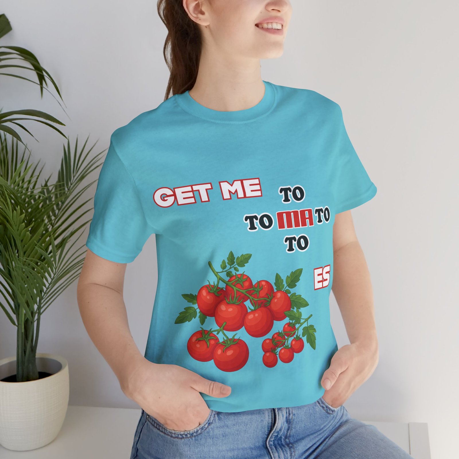 Woman wearing a blue Get Me To Ma To Toes vintage t-shirt with red tomato illustrations and retro typography.
