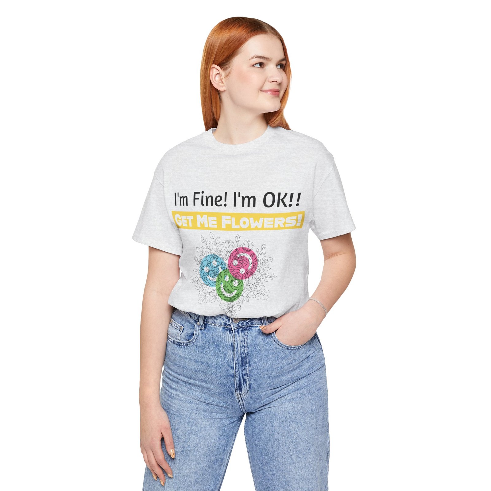 Woman wearing a grey crew-neck t-shirt with the text "I'm Fine! I'm OK!! GET ME FLOWERS!" and abstract colorful floral graphic.