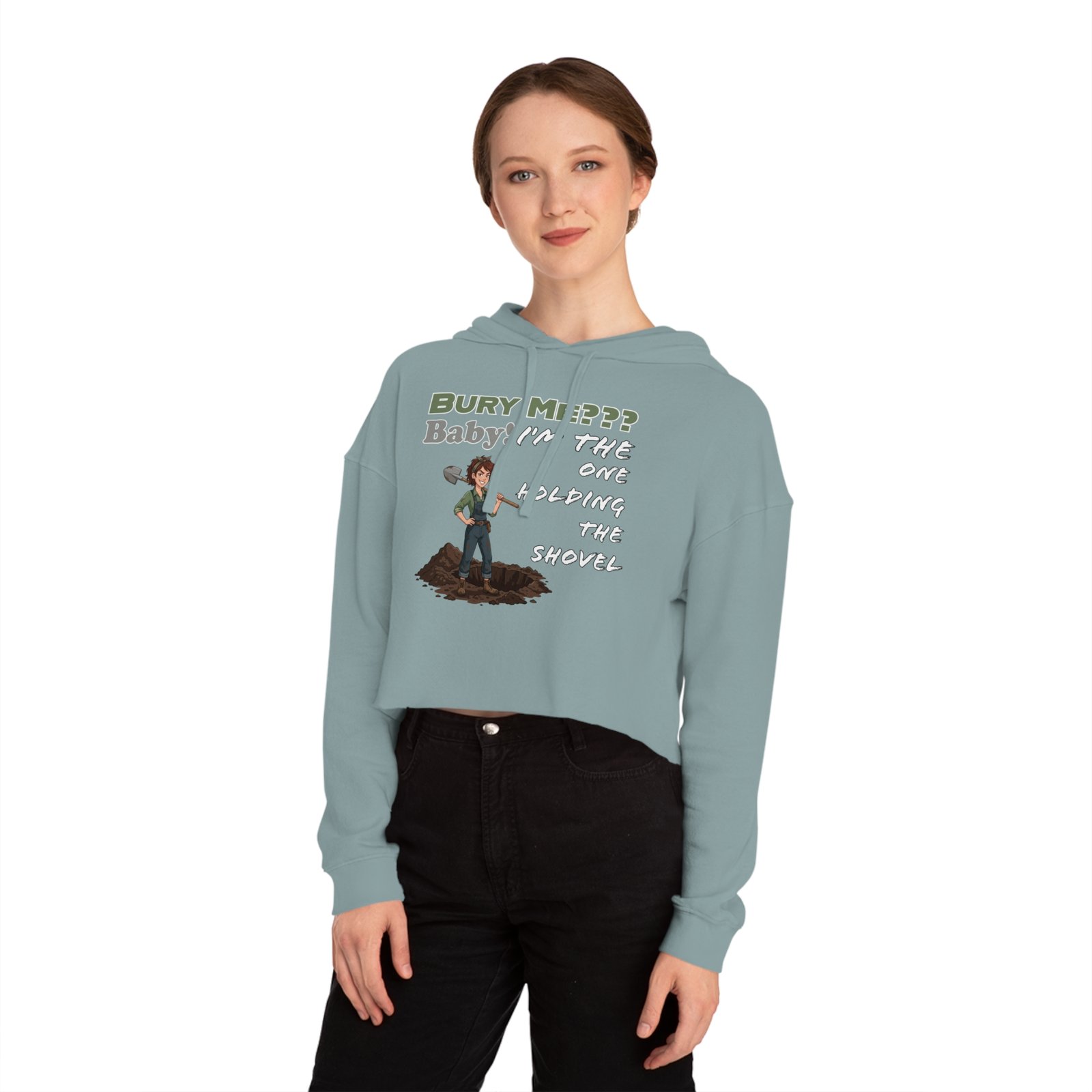 Woman wearing a light blue cropped hoodie featuring a character with a shovel and dark humor text.