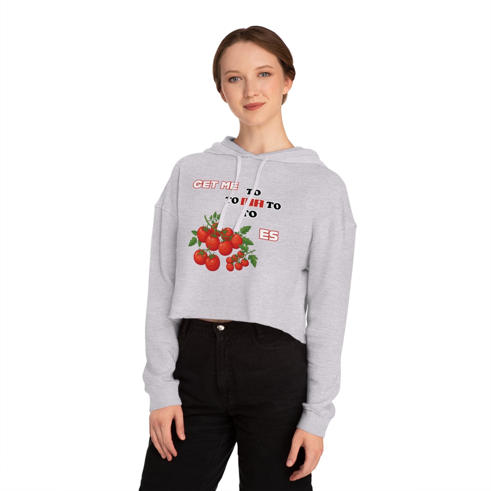 Woman wearing a light gray cropped hoodie featuring a hand-drawn tomato graphic and "Get Me to Tomatoes" text.