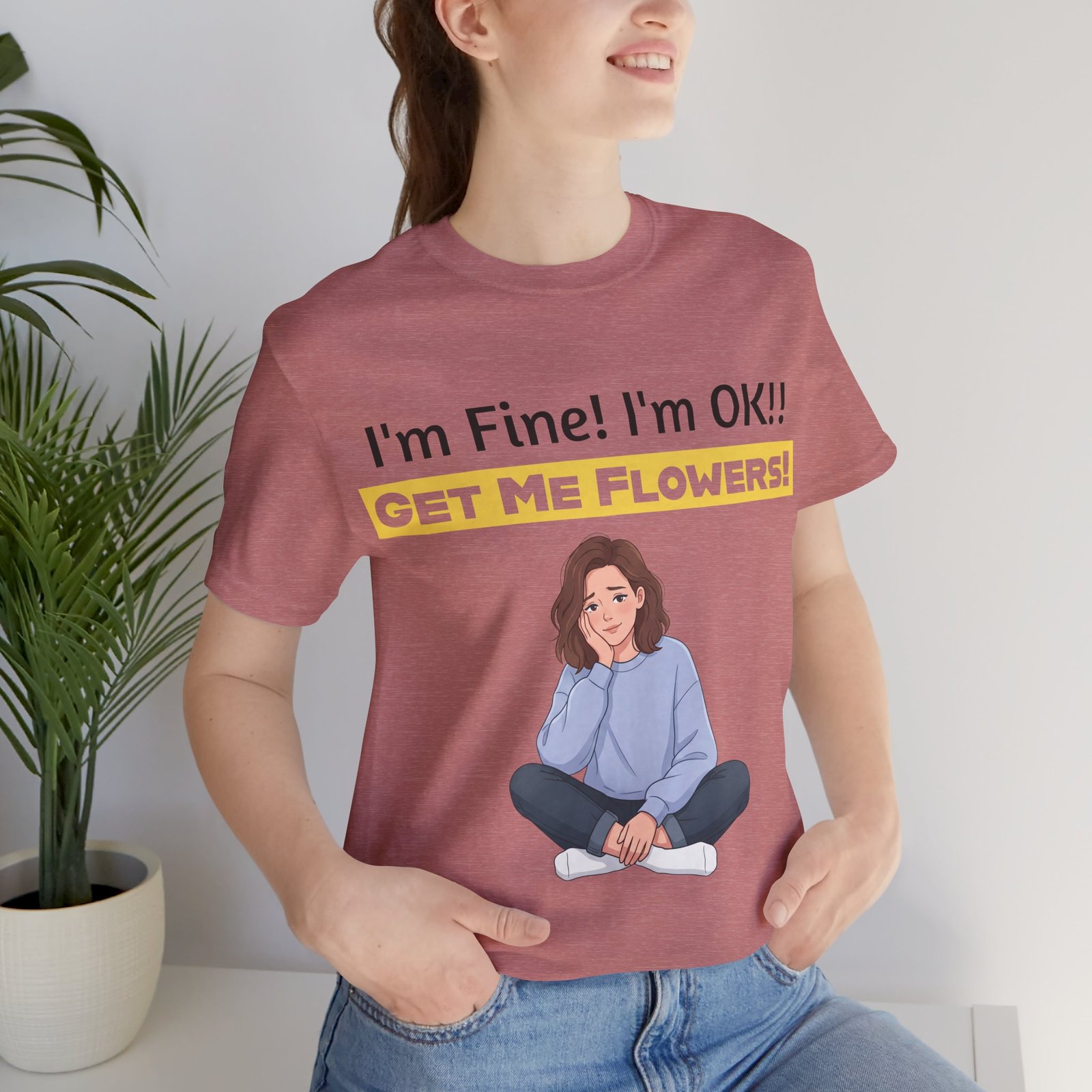 Woman wearing a mauve I'm Fine! I'm OK!! Get Me Flowers! Funny T-Shirt featuring an illustration of a relaxed woman.