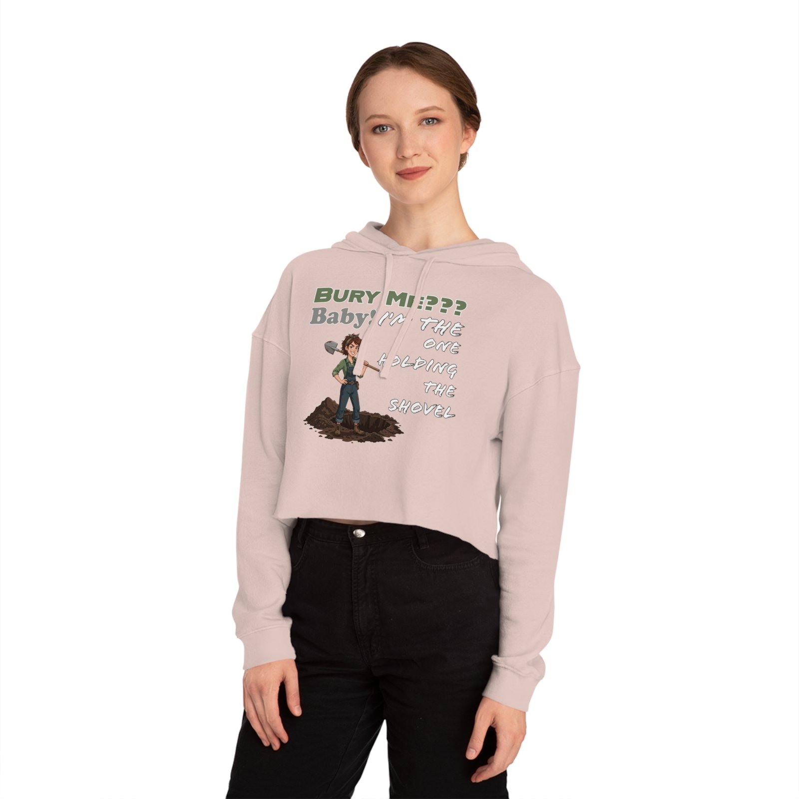 Woman wearing a pale pink cropped hoodie featuring a dark humor graphic of a character with a shovel.