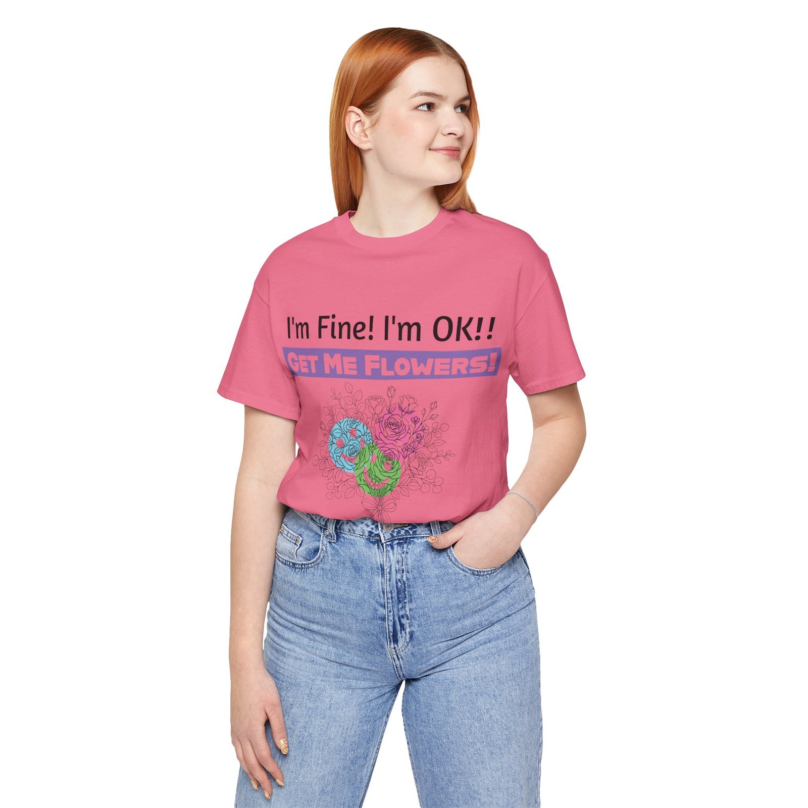 Woman wearing a pink graphic t-shirt with 'I'm Fine! I'm OK!! GET ME FLOWERS!' and a colorful floral print.