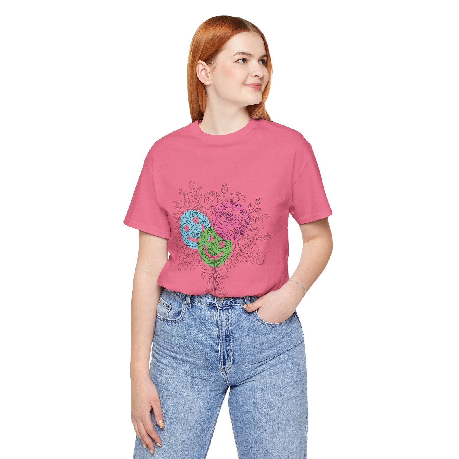 Woman wearing a pink T-shirt with a colorful hand-drawn floral yarn bouquet design in teal, magenta, and lime.