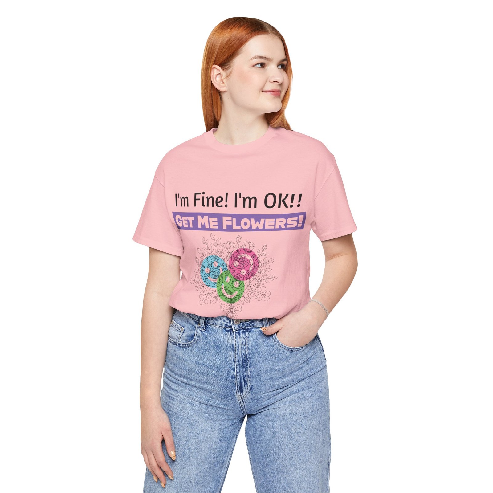 Woman wearing a pink t-shirt with 'I'm Fine! I'm OK!! GET ME FLOWERS!' text and colorful floral graphic.