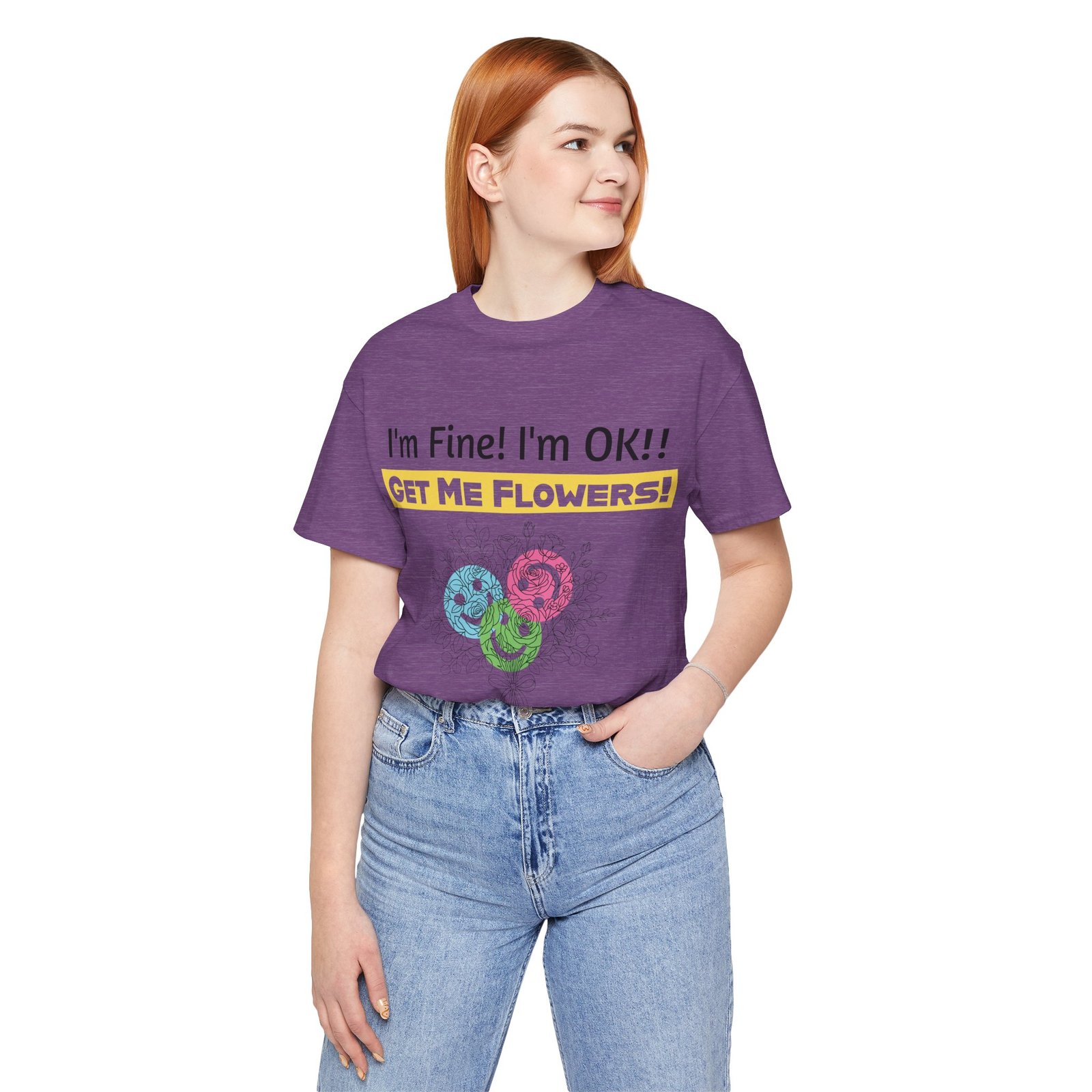 Woman wearing a purple crew-neck t-shirt with "I'm Fine! I'm OK!! GET ME FLOWERS!" text and colorful abstract blooms.