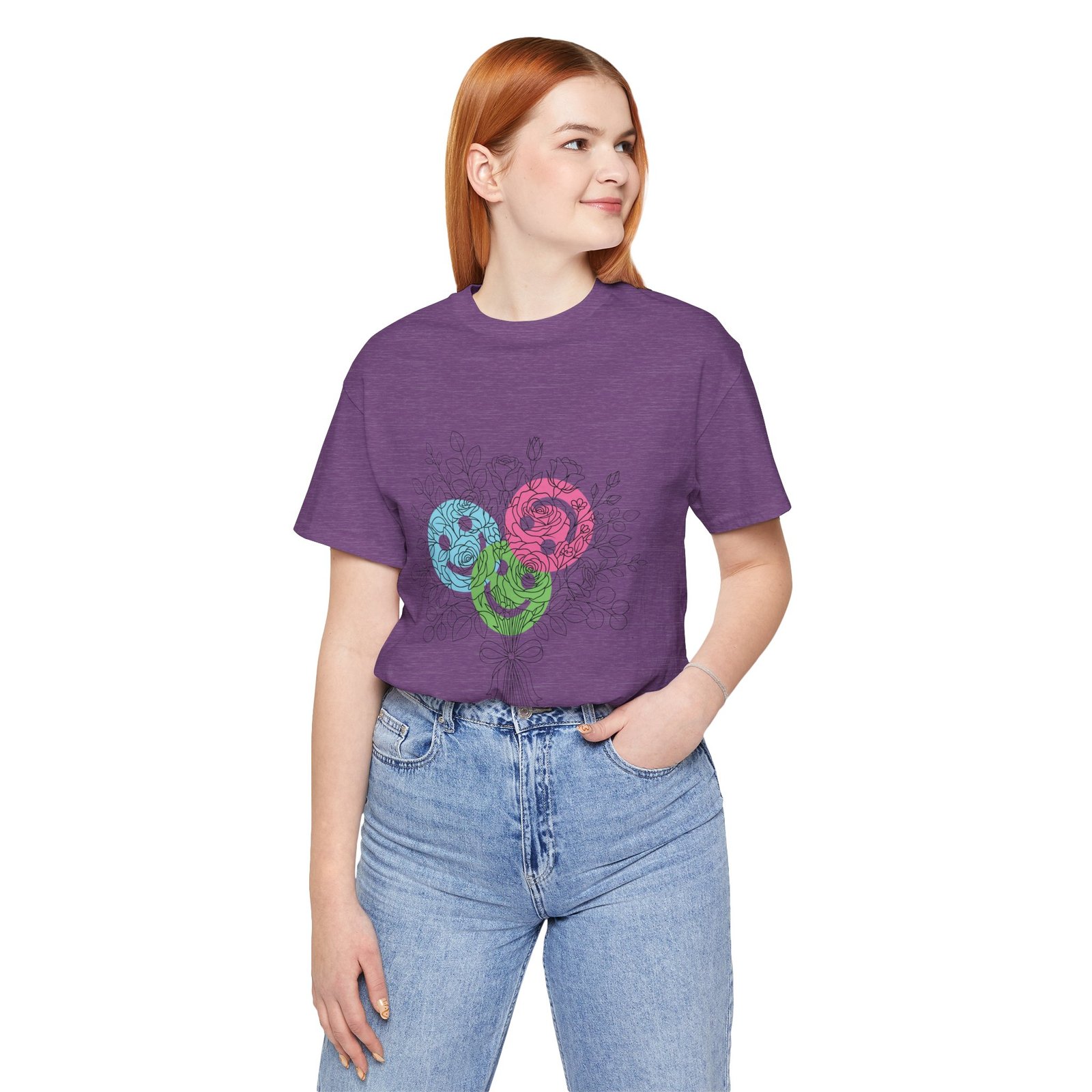 Woman wearing a purple t-shirt featuring a colorful floral yarn bouquet graphic in teal, magenta, and lime.